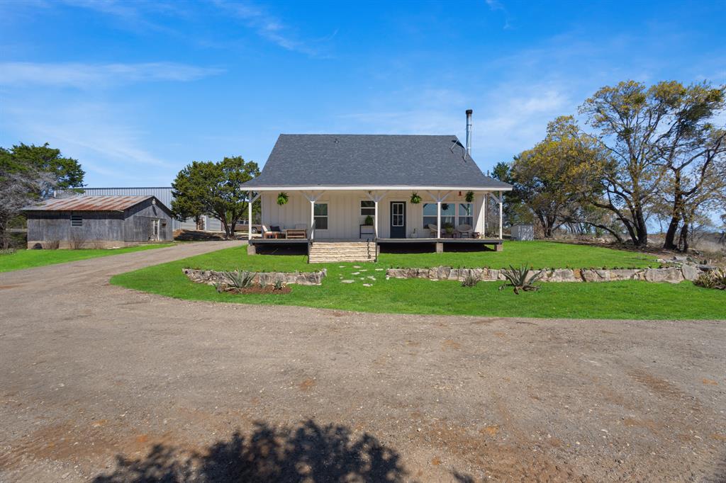 Here it is, the HOME you've been dreaming of in the coveted Tolar ISD. Nestled in almost 3.5 acres of mature trees, up on the hill with the most incredible views sits this thoughtfully renovated 5 bedroom, 3 bath home that feels like a giant hug the moment you walk in. An expansive covered front porch welcomes you into the large open concept living space flooded with natural light from the windows of every plant lovers dreams. A kitchen built to entertain with a huge island, inset cabinets, custom concrete countertops, gas range, coffee bar, 4 ft workstation sink, and walk in corner pantry coupled with a spacious dining room await all your memory-making gatherings. Space for everyone with 2 generous bedrooms and full bathroom downstairs with the Primary suite, 2 additional bedrooms and 3rd full bathroom tucked upstairs. Primary is it's own spacious retreat complete with walk in closet and adorable ensuite, dual vanity and walk in shower.  Back outside, you've got a shaded back and side yard and over 3 acres of privacy to road with perimeter fencing already in place. The oversized 40x50 workshop with electricity provides covered parking for vehicles, boats, RVs, you name it with plenty of room to spare. 14 ft tall pull through doors make parking the largest of toys a dream. There's even a 3rd structure complete with plumbing and electrical on a slab ready for you to bring your guest cottage, home office, or she shed dreams to reality with some imagination and  TLC. The original log cabin structure provides incredible strength and insulation with the sleek, new board and batten siding for a fresh exterior. New roof in 2026 and full renovation of every room and surface in the last 5 years. Come see it and fall in love with your next chapter today!