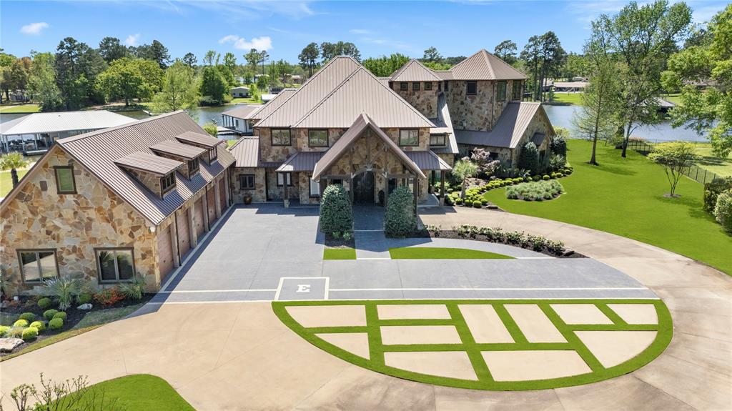 Welcome to the pinnacle of luxury lakefront living on nearly 2 acres of pristine waterfront. This private estate is thoughtfully designed for seamless indoor, outdoor living and resort-style comfort. A gated motor court and grand two-story porte cochère set the tone for the impressive elegance that awaits. Inside, you'll find 6 spacious bedrooms and 8 luxurious bathrooms, including a fully ADA-compliant suite for enhanced accessibility. The chef's kitchen features premium Wolf and Sub-Zero appliances, ideal for entertaining or everyday gourmet living. The home also includes a 700-bottle wine and gun room, a hidden safe room, an expansive living area, a soaring staircase, and an elevator that leads to a state-of-the-art media room and third-floor bar with stunning views of Lake Tyler. Car enthusiasts will appreciate the oversized 5 car garage with 12 foot doors, commercial-grade lift, and a separate 3 bay ATV garage. A Briggs & Stratton diesel propane generator and a six camera PTZ ISRSS Pro surveillance system provide superior safety and peace of mind. Step outside to discover an entertainer’s paradise a custom saltwater pool and spa with heating, chilling systems, outdoor kitchen, fireplace, covered lounge area, concert quality surround sound, misting and bug control systems, and a pergola covered smoker with fire pit, all enhanced by ambient landscape lighting. The private boathouse retreat includes a kitchenette, bedroom, bathroom, 4 bed bunk room, 3 boat lifts, 3 jet ski lifts, and a dedicated jet ski platform, offering everything needed for luxurious lake life. This estate is a rare opportunity to own a truly exceptional home where no detail has been overlooked. Schedule your private tour today and experience elevated waterfront living like never before.