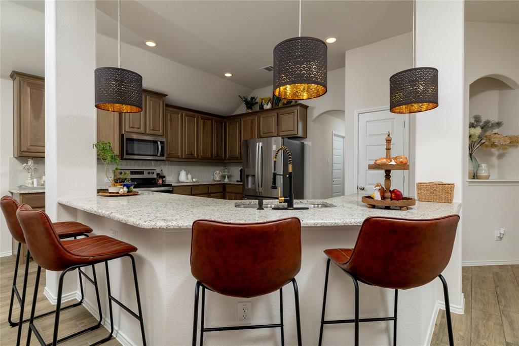 9824 Mescalbean Boulevard showcases one of the most sought-after floorplans in the subdivision—known for its functionality, flow, and everyday livability. This beautifully maintained 3-bedroom, 2-bath home offers a bright open-concept layout, perfect for modern living and entertaining. Natural light fills the spacious living area, seamlessly connecting to the dining space and well-appointed kitchen, creating an ideal setting for gatherings or quiet evenings at home. Designed with comfort and convenience in mind, the split-bedroom layout provides privacy, while the primary suite offers a relaxing retreat. Step outside to a large backyard with covered patio, perfect for outdoor entertaining, pets, or future enhancements—adding both lifestyle appeal and long-term value. Located just minutes from shopping, dining, and major highways, this home offers an easy commute and is approximately 10 minutes from Fort Worth, giving you quick access to top restaurants, entertainment, and cultural attractions. Nearby parks and green spaces further elevate the lifestyle, making this an ideal setting for buyers seeking both convenience and community.

A rare opportunity to own a highly desirable plan in a prime location—schedule your private showing today.