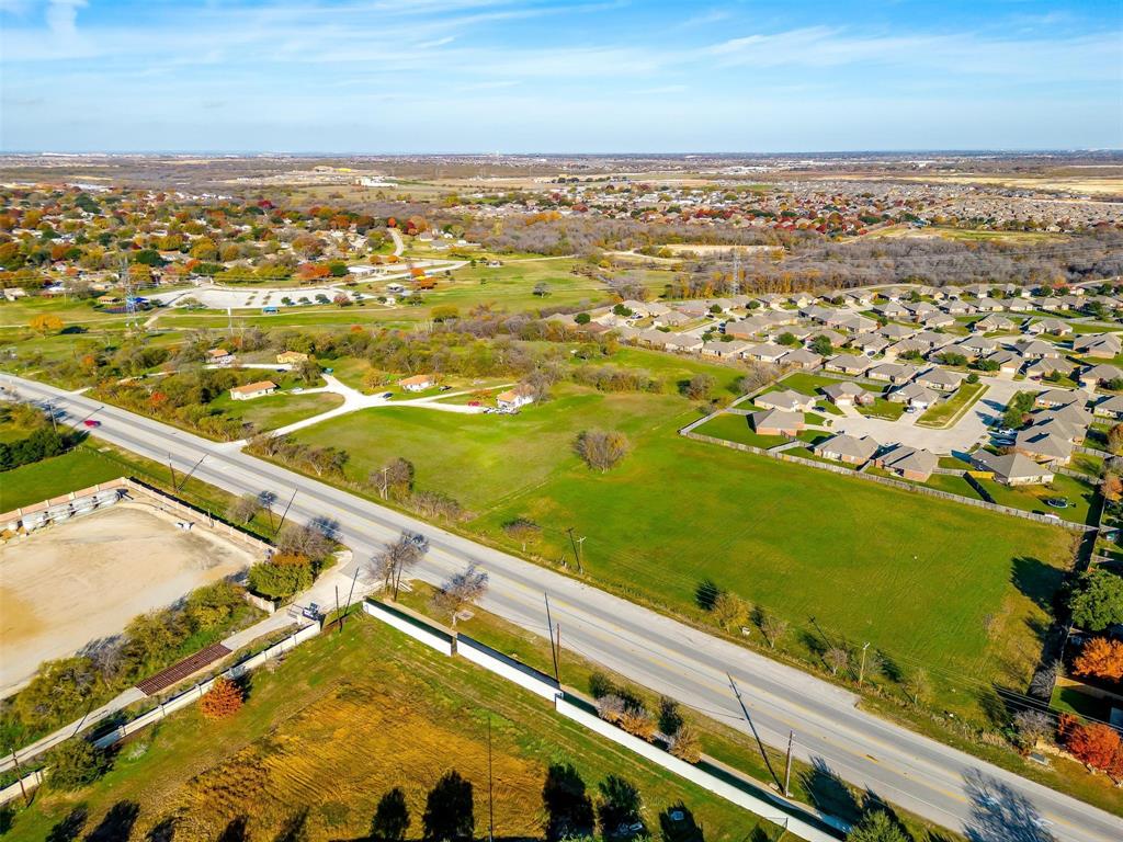 Positioned in the heart of one of South Tarrant County's fastest-growing corridors, this 12.75-acre commercial tract offers a rare opportunity to develop in an area already surrounded by rooftops, retail, and community amenities.

Located on East Main Street (FM 1187), the property is adjacent to established residential neighborhoods, near Bicentennial Park, and just minutes from Walmart, Planet Fitness, Sonic, McDonald's, and numerous other national retailers. The site's General Commercial zoning supports a wide range of potential uses including retail, medical, office, mixed-use, hospitality, and service-oriented development.

Infrastructure is already in place to support future development. A 10-inch water line runs along the west side of the property, while sewer service is stubbed to the north between Lots 28 and 29 of the adjoining residential development, helping reduce upfront utility extension costs.

With strong area demographics, continued residential growth, and excellent visibility along one of Crowley's primary commercial corridors, this property is well-positioned for the next phase of development.