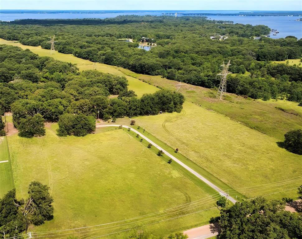 Hard-to-find acreage in Malakoff offering space, privacy, and versatility. Situated on over 14 acres with two ponds, this property delivers a unique opportunity for those seeking a peaceful country setting just minutes from Cedar Creek Lake. The 3-bedroom, 2-bath home features a spacious living area with wood-paneled walls, built-ins, and a brick fireplace. Large windows and glass doors bring in natural light and provide views of the surrounding trees and landscape. The flexible layout offers multiple living and dining spaces for everyday living or entertaining.
Recent updates include new carpet in the living room, hallway, and owner’s bedroom, along with luxury vinyl plank flooring in the ensuite bathroom.
Outdoors, enjoy a mix of open lawn and mature trees, along with two ponds that add to the property’s character and usability. Additional improvements include a workshop with electricity, covered equipment storage, and a large, enclosed storage area, all positioned on a concrete pad. A full concrete driveway with gated entrance provides easy access.

This property offers a range of potential uses and is conveniently located near local amenities while maintaining a private, rural feel.