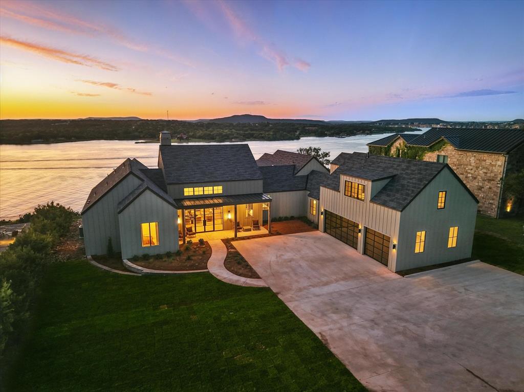Turn Key Elegance on Possum Kingdom Lake

Indulge in the pinnacle of lakefront luxury with this breathtaking 5-bedroom, 5.5-bath estate nestled in the prestigious Sportsmans World community at Possum Kingdom Lake. Gracing over half an acre of prime waterfront property, this architectural gem boasts expansive indoor-outdoor living, sophisticated design, and five-star resort-style amenities.

Masterfully envisioned by a renowned Dallas design team, every inch of this exquisite residence exudes elegance and comfort. From the soaring ceilings to the floor-to-ceiling windows, natural light cascades through an open-concept layout that seamlessly blends modern sophistication with relaxed lakehouse charm. The chef's kitchen is a culinary dream, outfitted with custom cabinetry, statement lighting, and premium appliances worthy of the most discerning entertainer.

The lavish living and dining spaces extend effortlessly onto an expansive patio wrapped in seamless glass, creating a stunning panoramic connection to the lake beyond. Each bedroom is a private retreat with its own spa-inspired ensuite bath, while the opulent primary suite commands sweeping water views, a designer soaking tub, and a serene ambiance that invites pure relaxation.

Step outside to your personal sanctuary where a sparkling private pool meets the tranquil waters of Possum Kingdom Lake. Spend your summer days sunbathing, boating, or dining al fresco beneath the Texas sky.

Offered fully furnished and turn key, this exceptional home invites you to experience effortless elegance from the moment you arrive. Ownership includes access to Sportsmans World’s elite amenities: a private marina, general store, entertainment pavilion, tennis courts, and community pool.

This is more than a home—it's an invitation to live life beautifully on the lake.