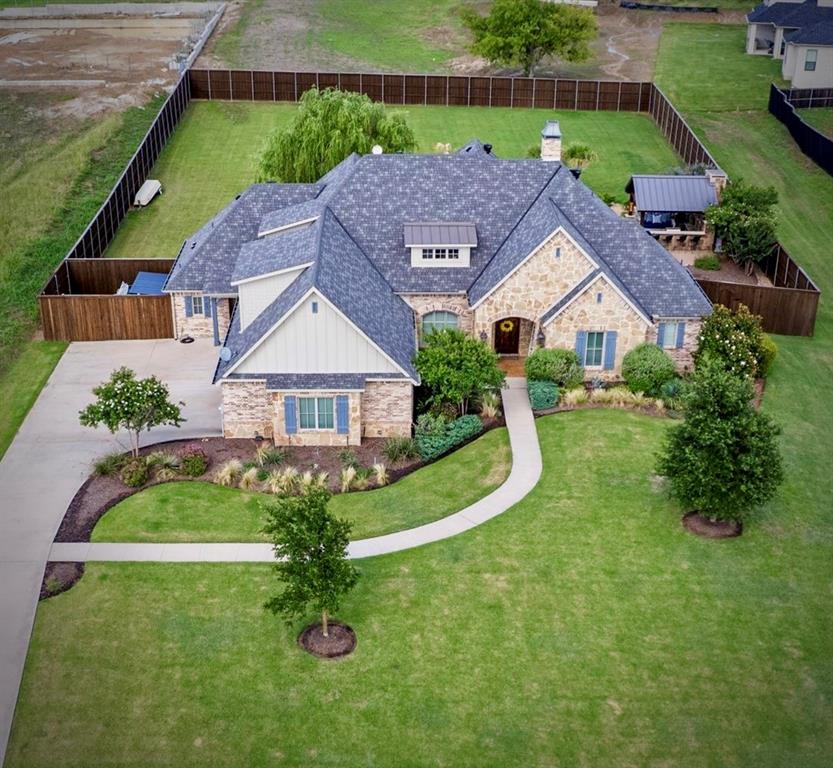 OPEN HOUSE SAT 11TH 1-3 PM. Luxury, comfort, and resort-style living come together in this exceptional custom home built in 2019! Offering 3,774 square feet, this thoughtfully designed home features 4 bedrooms plus a dedicated office that can easily serve as a 5th bedroom, 3.5 baths, and a 3-car garage. The open-concept floor plan showcases soaring ceilings, rich hardwood floors, abundant natural light, and designer finishes throughout. The chef’s kitchen is the heart of the home, featuring a large marble island, custom ceiling-height cabinetry, farmhouse sink, premium appliances, designer lighting, and generous workspace overlooking the spacious living area. The private primary suite offers a spa-like retreat with dual vanities, an oversized walk-in shower, and luxurious finishes. Upstairs provides flexible living space ideal for guests, a game room, or additional bedroom. Step outside to your own backyard paradise featuring a custom pool with tanning ledge, raised spa, dramatic rock waterfall, lush landscaping, and an incredible outdoor living pavilion complete with an outdoor kitchen and fireplace—perfect for entertaining or relaxing year-round. Located in a desirable lakeside community, you’ll enjoy close proximity to the lake with convenient lake access for boating, fishing, kayaking, or simply enjoying the scenic surroundings. Every detail of this beautifully maintained home was designed with both elegance and functionality in mind. This is more than a home—it’s a lifestyle. Schedule your private showing today!