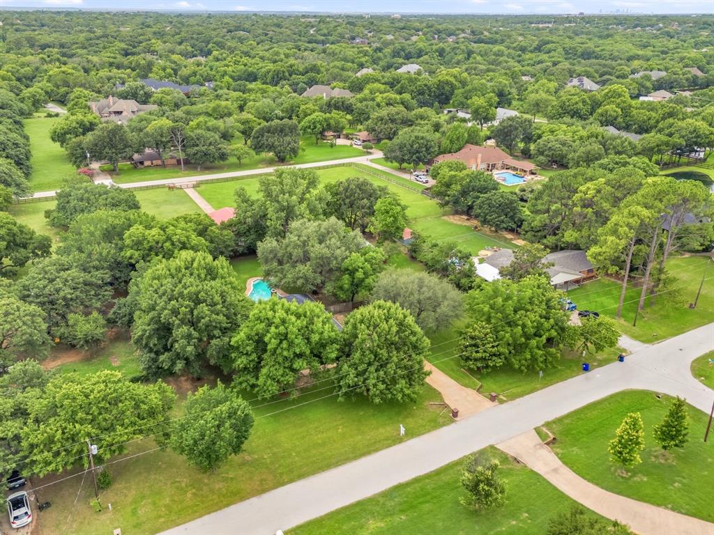 Build your dream home, using your builder of choice, on this R40-zoned land, giving you the freedom to bring your horses and create the lifestyle you’ve been dreaming of! Elegant single story home currently built that may be added onto if wanted. The property includes a versatile barn with a bath and kitchenette, perfect for workshops or equestrian needs. Wide-open grounds offer room to roam, relax, and enjoy the peaceful setting — all while staying close to top-tier schools, shopping, and dining. No HOA! Conveniently located between Dallas and Fort Worth, minutes from the Dallas Fort Worth International Airport. Nearby Southlake Town Square and Historic Downtown Grapevine offer endless shopping and dining options!