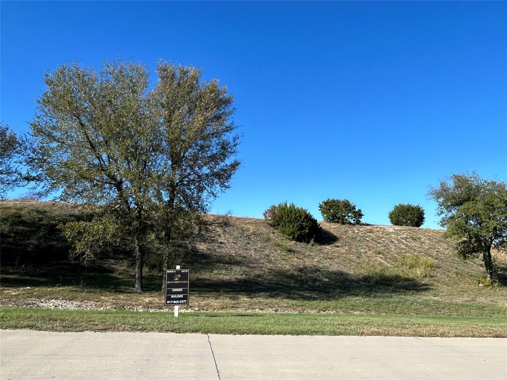 One of the last remaining hilltop lots in Bear Creek Ranch offering 180 degree rural hilltop views all the way to the downtown Fort Worth skyline. 2+ acre luxury estate lot within the gated community overlooking mature trees and Bear Creek below. Includes a concrete driveway up the side to the crest of the hilltop lot. No City Taxes - Parker County - Award-Winning Aledo ISD - Private Water Well & Septic Systems - No Water Bills - Tri-County Electric - Buried Propane Tank Allowed - Any Custom Builder - No Timeframe to Build - Minimum Living Space: 3,500 SF - 90% Exterior Masonry Requirement - Iron or Masonry Fencing Only - HOA Approval Required for all Homes