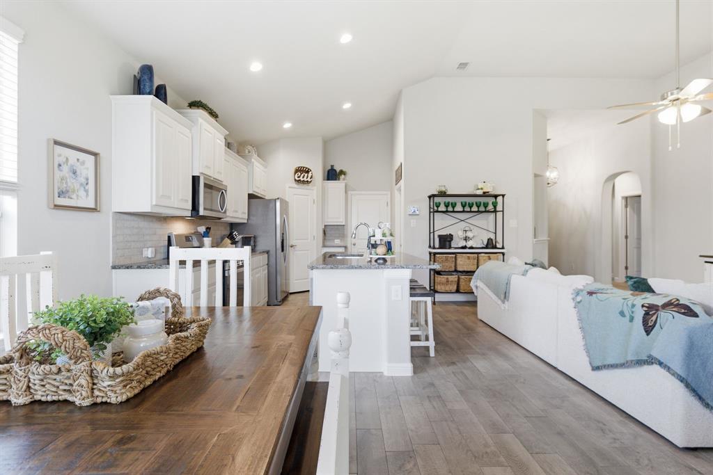 Welcome to this beautiful one-owner, single story home in desirable Basswood Crossing.  Move-in ready and thoughtfully designed for both everyday living and effortless entertaining.  Step into this open-concept living area where backyard views flood the space with natural light. The living room with vaulted ceiling centers on a cozy fireplace and offers direct sightlines to the covered patio and backyard—perfect for keeping an eye on outdoor activities while relaxing indoors. The heart of the home is the chef-friendly kitchen: abundant cabinetry, an oversized island, granite countertops, stainless steel appliances, and a walk-in pantry make meal prep and hosting a breeze. Whether serving family dinners or entertaining guests, this layout supports effortless circulation between kitchen, dining, and living areas. The study with bay window, provides a quiet retreat for work or make it the perfect 4th bedroom. The split-master floor plan provides privacy from busing family life. Retreat to the primary bedroom suite designed for comfort and convenience. A generous walk-in closet, dual sinks, separate glass-enclosed shower, and a garden tub create a spa-like atmosphere to unwind after a long day. Two additional bedrooms are well-sized and positioned for privacy and flexibility - ideal for guests, kids, or a hobby room. Outdoor living shines here: enjoy a large backyard with a covered patio for everyday lounging, plus an additional entertaining patio finished in flagstone with a pergola and soothing water feature—an inviting setting for outdoor dining or peaceful mornings with coffee. Practical touches include a three-car garage and meticulous one-owner care throughout. This home blends timeless curb appeal with modern amenities and thoughtful design—move right in and enjoy the lifestyle Basswood Crossing has to offer. Schedule your showing today.