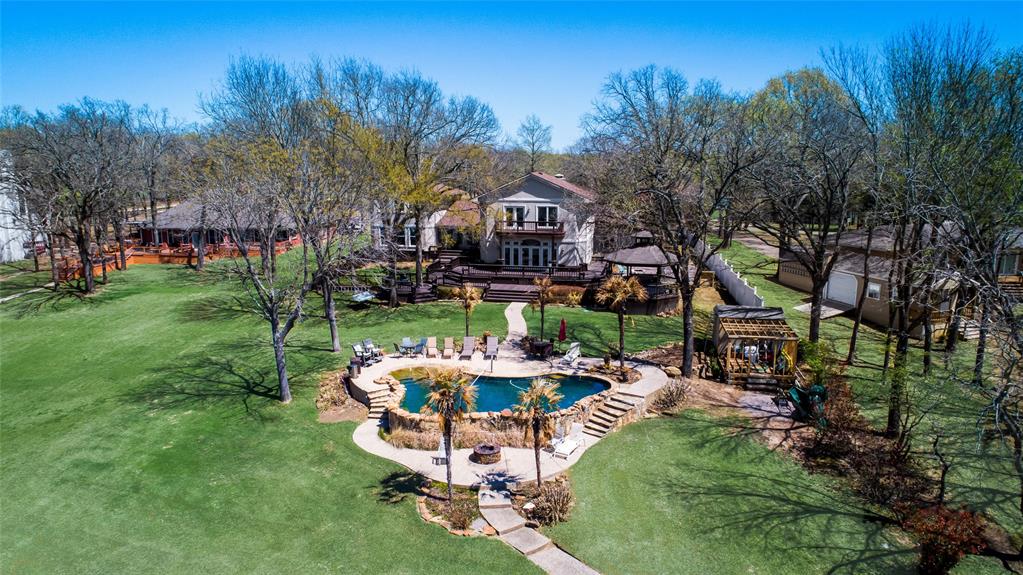 Lakeside Paradise on Richland Chambers!!! Perfect for your large family and gatherings. Enjoy beautiful views of the sunset every evening, modern rock POOL with beach entry, large 2 level boat house with all new wood and stain, 2 jet ski lifts and 1 boat slip. The expansive multi-level outdoor deck and gazebo with hot tub. The House boasts THREE huge Primary suites with private bathrooms plus 2 oversized bedrooms. The house incorporates lots of fun amenities with a spacious game room, theater, exercise room. The beautiful gourmet kitchen is perfect with lots of space to cook and entertain; granite island with seating; Subzero, Dacor, Wolf appliances. No HOA on a Private - QUIET- Secluded Road. *Multi-Generational Living* 

Turnkey (furniture Negotiable) Ready to move in!