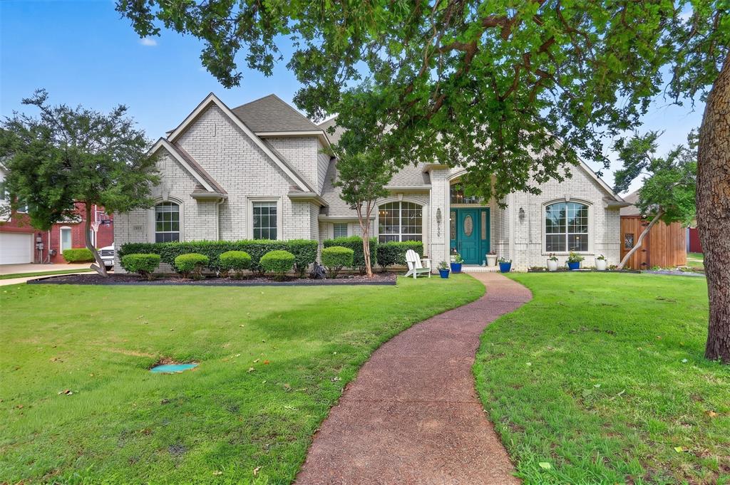 Set on nearly half an acre in a quiet cul-de-sac across from a picturesque pond, this spectacular 6-bedroom home with a 4-car garage offers spacious living, peaceful privacy, and timeless charm. Designed for modern living, the open-concept floor plan features a split-bedroom layout adorned with elegant crown molding, wrought iron spindles, a cozy fireplace, upgraded ceiling fans, and abundant windows that flood the home with natural light. The main level also hosts a first-floor in-law suite graced with a kitchenette including a full stove and sink, a walk-in closet, and a dual-sink vanity. Working remotely is a pleasure in the home office, complete with French doors and access to a private side deck. Cooking is a breeze in the pristine kitchen boasting granite countertops, a large island with lots of storage, a pantry, and a clever appliance garage. End your day in the secluded primary suite including a sitting area, direct patio access, a dual-sink extended vanity, a jetted tub, a separate shower, and an expansive walk-in closet with built-ins. Convenience is key with a central vacuum system and a deluxe laundry room offering built-in cabinets, a sink, and room for a freezer. Upstairs, entertainment thrives in a huge game room that opens to a balcony overlooking the backyard, alongside a large media room for perfect movie nights. Enjoy the outdoors in your massive backyard including a covered patio with an extended open patio, a storage building, greenhouse, and plenty of room to relax, unwind, and play. An oversized 4-car garage plus an additional parking pad behind the fence provides plenty of space for vehicles, trailers, or extra storage. Conveniently located near top-rated schools, and in close proximity to The Shops at Highland Village. Take a first-person look at this gorgeous home! Click the Virtual Tour link to see the 3D Tour!