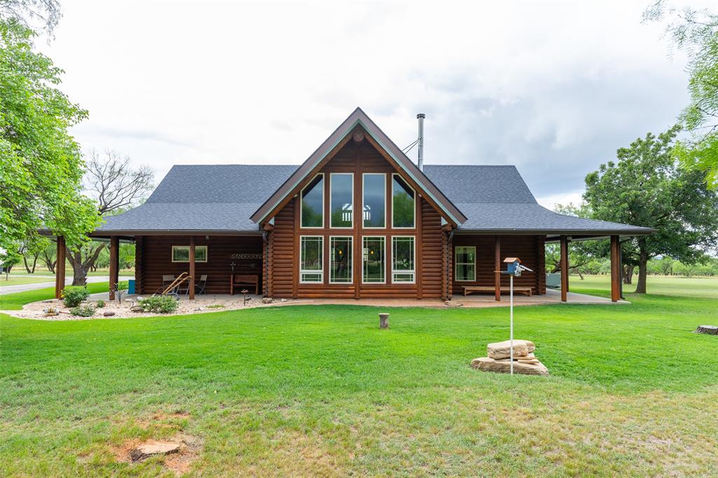 Escape to the peace and privacy of country living with this immaculately maintained log home nestled on 8.5 breathtaking acres just outside the city limits. Blending rustic charm with spacious comfort, this stunning three bedroom, two bath home offers spectacular views through dramatic floor to ceiling windows that flood the main living area with natural light.

Inside, you’ll find an inviting open-concept design featuring soaring vaulted beamed ceilings, a cozy wood stove, and a loft living area overlooking the grand main living space below. With two separate living areas, there is plenty of room for entertaining, relaxing, or hosting family and guests.

The authentic log construction not only creates timeless mountain lodge appeal but also provides excellent insulation and energy efficiency year round. Step outside and enjoy the beauty of the surrounding landscape from the expansive wraparound porch which is the perfect place for morning coffee, evening sunsets, and peaceful country nights.

The property also includes a large garage shop complete with a full bathroom, offering endless possibilities for hobbies, storage, workspace, or additional guest accommodations.

If you’ve been searching for a private retreat with unmatched character, modern comfort, and room to roam, this exceptional property delivers it all.