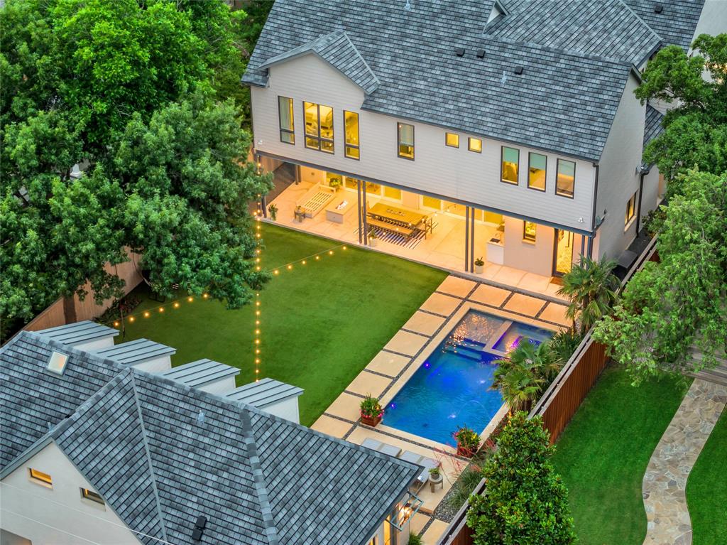 Exceptional home built by Phillip Jennings Custom Homes on oversized 65x209 lot in Highland Park. Grand foyer w 11ft ceilings & natural light through floor-2-ceiling windows on 1st flr, is flanked by formal dining rm & study or guest bedrm w full bath, adorned w custom built-ins. Wide center hallway leads to family rm, w 10ft sliding glass doors, gas FP, built-ins & adjacent wet bar. Kitchen equipped w SS appliances, large center island & walk-in pantry. 1st flr powder bath, mudrm, & home mgmt office. 2nd flr primary suite w coffered ceiling & views of backyard. Primary bath w sep vanities, garden tub, wall of built-ins & 2 walk-in closets. 2nd flr feat 3 addtl bedrms, w ensuite baths & walk-in closets, utility rm & game rm. Backyard oasis w covered loggia, built-in grill, dining & fire pit. Huge turfed yard, pool, spa & outdoor shower.  Separate quarters w bedrm & ba, living, kitchenette & walk-in storage. Home complete w 4 garage spaces; 4th garage w HVAC is currently home gym.