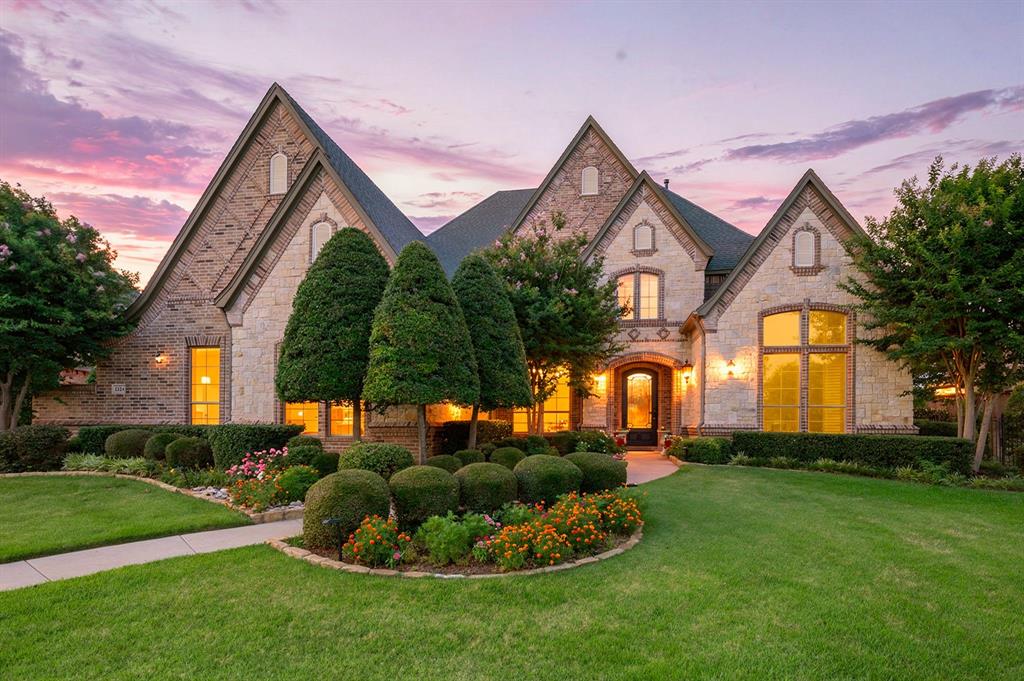 Tucked away on a quiet cul-de-sac in prestigious Danbury Parks, this exceptional custom home offers timeless craftsmanship, luxurious amenities & a backyard designed for unforgettable gatherings. Situated on over half an acre with an electric gated driveway, 4-car garage, mature trees & no homes directly behind, this property combines privacy with elegance. From the moment you enter through the elaborate iron front door, you’ll be captivated by rich hardwood floors, extensive millwork, plantation shutters, soaring ceilings & architectural details rarely found today. The private study showcases a stunning coffered wood ceiling, while the formal living room features custom built-ins & one of three fireplaces. Entertain with ease in the elegant dining room complete with a butler’s pantry, wine cooler & wine room. The chef’s kitchen features granite countertops, a two-tier island with prep sink, JennAir gas range, pot filler, warming drawer, double convection ovens, built-in microwave, Sub-Zero refrigerator, abundant cabinetry & a large walk-in pantry. The breakfast area overlooks the backyard oasis. The primary suite offers a sitting area & spa-inspired bath with a Jacuzzi tub, travertine shower, dual vanities, makeup station & custom closet with built-ins. A downstairs guest suite with full bath provides flexibility for visitors or multigenerational living. Upstairs, every bedroom features a private bath & walk-in closet. The oversized game room offers space for a pool table, card table, kitchenette with refrigerator & microwave, plus an exercise or media room. Outside, enjoy a saltwater pool with beach entry, waterfall & spa, outdoor kitchen, fireplace, covered living area, sport court, large grassy yard & wrought iron fenced pool area. Additional features include central vacuum, tankless water heater, intercom, walk-in attic storage, back staircase, mudroom & utility room. Located in Keller ISD, this remarkable home offers luxury living at its finest.