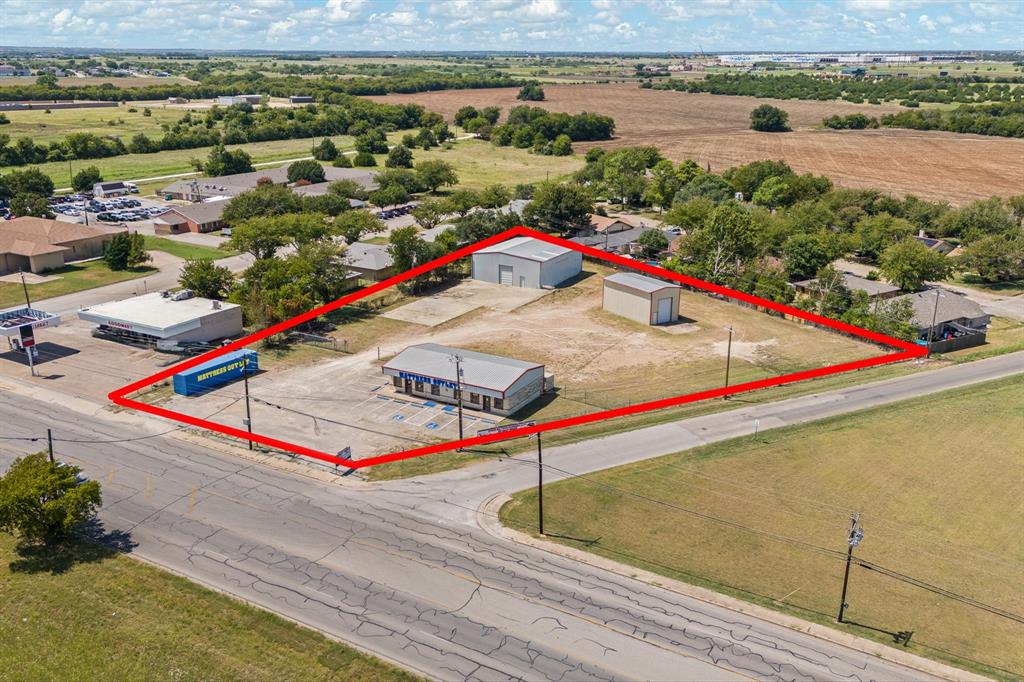 Exceptional commercial property with high visibility on W Kilpatrick St in fast-growing Cleburne, TX. This ±1.58-acre site is located in the RC – Regional Commercial District, allowing for a wide range of retail, service, and business uses that serve both local and regional markets. City traffic counts show ~6,800–7,800 vehicles per day, offering excellent exposure for businesses seeking accessibility and growth potential.

The ±1,872 SF front office-retail area includes two suites that can operate independently, each with its own HVAC and hot water heater, along with three bathrooms and three interior storage rooms with utility sinks. Polished stained concrete floors and 10 dedicated parking spaces make this a flexible option for professional offices or customer-facing retail.

Behind the office are two warehouse buildings: ±3,178 SF with a large roll-up door and ±980 SF of additional space, plus secure fenced storage areas. Heavy-duty iron racks and gated access with barbed wire fencing provide excellent functionality for contractors, logistics-distribution, service businesses, or specialty retail needing both showroom and storage.

With a total of ±6,030 SF under roof, this property offers a rare office + warehouse + yard combination that is hard to find in Cleburne. Permitted uses under RC zoning include retail, restaurants (including drive-thru), banks, auto service, distribution, fitness-training, farm & ranch supply, and more (excluding furniture-mattress retail per owner).

Conveniently located near Chisholm Trail Parkway, Hwy 67, and I-35, this property provides easy access to Burleson, Joshua, Keene, Godley, and the greater Fort Worth area. With population growth and commercial development surging along this corridor, this site is an excellent choice for an owner-user business with strong future income potential.