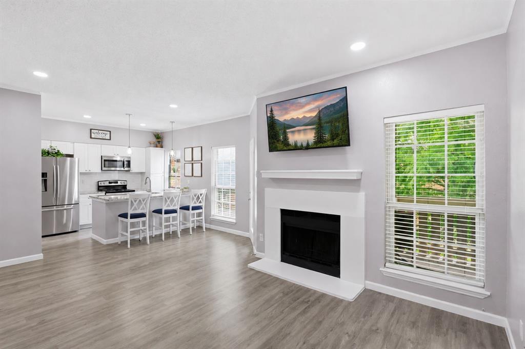 Location, location, location! This truly move-in ready condo has been beautifully renovated with new flooring, fresh paint, and updated kitchen and bathrooms throughout. Step inside to an open-concept layout featuring a spacious living area with a cozy fireplace, creating the perfect space for relaxing or entertaining guests. The stunning kitchen is sure to impress, offering stainless steel appliances, modern finishes, and ample space for cooking and gathering. The spacious primary suite includes a private ensuite bathroom, while the oversized secondary bedroom is filled with natural light and offers flexibility for guests, a home office, or additional living space. Enjoy low-maintenance living with an HOA that covers water, sewer, trash, common area maintenance, and backyard upkeep. Additional conveniences include a designated carport and a private storage unit. Ideally located in the heart of Plano, this home is within walking distance of Medical City Plano and just minutes from grocery stores, CVS, shopping, dining, and a nearby movie theater. Whether you're a medical professional, first-time buyer, downsizer, or investor, this property offers an unbeatable combination of comfort, convenience, and location. Don't miss this opportunity to own an updated, low-maintenance home in one of Plano's most convenient locations!