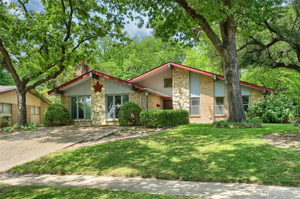 Mid-Century Modern Opportunity in Lochwood Near White Rock Lake! Tucked beneath a canopy of mature trees, this 3-bedroom, 2-bath home is a true mid-century modern gem full of character and ready for its next chapter. Inside, you’ll find a spacious layout with an oversized family room anchored by a striking stone fireplace. The primary bedroom and dining room both offer direct access to the patio, creating a seamless connection to the outdoors. Both bathrooms retain their original vintage finishes, presenting a rare opportunity to restore or reimagine them to your personal style.

Step outside and discover what truly sets this property apart—a lush, multi-level backyard retreat featuring towering trees, flowering blooms, ferns, and thoughtfully designed aggregate walkways in both the front and back yards. Unique touches such as wrought iron gates on each side, an aviary bird cage, empty koi pond, and dedicated bricked grill area create a one-of-a-kind outdoor setting with endless potential.

Located in the highly sought-after Lochwood neighborhood, known for its mature trees and scenic creeks, residents enjoy access to Lochwood Park featuring walking trails, tennis and pickleball courts, a playground, basketball court, and covered party pavilion. Additional highlights include rear alley access with extra parking and an unbeatable East Dallas location just minutes from White Rock Lake, Dallas Arboretum and Botanical Garden, major highways, and some of East Dallas’ favorite local restaurants and shopping destinations. This is a rare opportunity to create something special in one of East Dallas’ most beloved neighborhoods.
