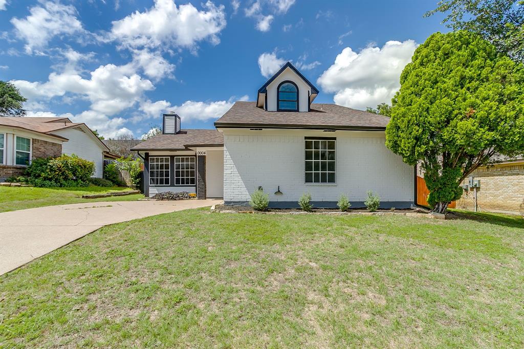 Welcome to 10004 Pack Saddle Trail in Fort Worth! This charming home brings together bold style, easy living, and a backyard that is ready for sunny Texas days. From the curb, the crisp white exterior with black accents gives the home a fresh, modern look, while the welcoming entry and attached garage add everyday convenience. Inside, you’ll find a light and airy layout with vaulted ceilings, statement ceiling beams, updated flooring, and a dramatic painted brick fireplace that gives the living room a cool, cozy focal point. The kitchen keeps things sleek with white cabinetry, dark countertops, stainless steel appliances, modern hardware, and a view right out to the backyard. French doors bring in great natural light and make indoor-outdoor living feel easy. The spacious upstairs bedroom offers plenty of room to unwind, complete with updated flooring, ceiling fan, wall-mounted TV setup, and generous closet space. Outside, the fenced backyard is a standout, with plenty of grassy space, mature trees, and a covered pergola-style patio that is perfect for relaxing, grilling, entertaining, or just enjoying a little fresh air. Located in Fort Worth, this home offers a great blend of style, comfort, and practical updates without feeling overdone. Whether you are looking for your next home or a smart investment opportunity, Pack Saddle Trail is full of personality and ready to make a great first impression.