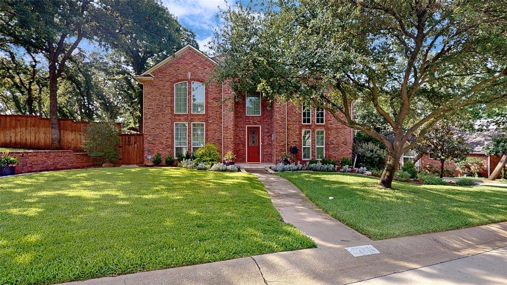 Stunning 2-story nestled beneath mature trees! Situated on a third-acre lot in the lakeside community of Highland Shores, this beautiful home offers a perfectly landscaped front lawn and brick elevation. Inside you will find 4 bedrooms, 3.5 baths, formal dining area, dedicated home office with built-ins and French doors, and 2-car garage! A first floor bedroom with ensuite bath is ideal for guests or in-laws! Upgrades and amenities include rich hand-scraped hardwoods and shutters throughout main living areas, spacious family room with towering ceilings and floor-to-ceiling brick fireplace, extensive crown molding and trim throughout, designer paint tones, and MORE! Kitchen located at the heart of the home boasts granite countertops with a stone backsplash, abundance of cabinetry and counter space, stainless appliances including double ovens and a Viking cooktop, and two adjacent dining areas making entertaining a breeze. Primary retreat with direct balcony access overlooking the backyard offers a luxurious ensuite bath with dual sinks and makeup vanity, two walk-in closets, freestanding tub, and separate shower. Two additional bedrooms sharing a Jack and Jill bath complete the second level. Incredible backyard is complete with sprawling patios, mature shade trees, and a hot tub!