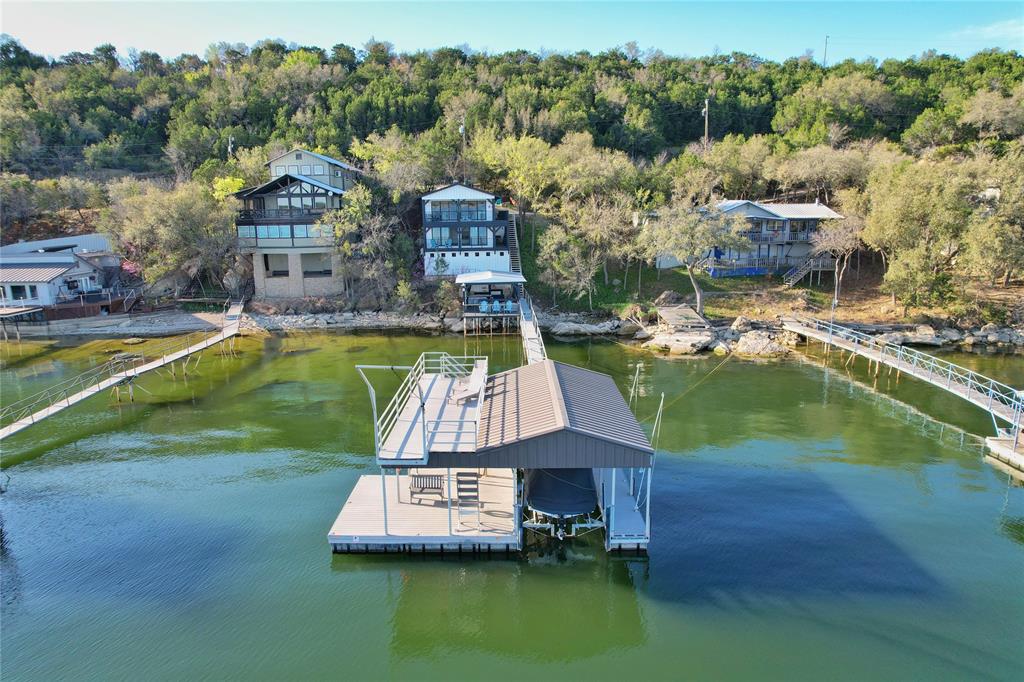 Waterfront living at its finest on Possum Kingdom Lake. This beautifully updated 3-bedroom, 2-bath lake home offers incredible views, deep water access, and comes mostly furnished, making it move in or rental ready.

The home features an open-concept layout designed for lake life, with spacious living areas, abundant natural light, and multiple spaces to relax or entertain. Two separate living areas provide flexibility for hosting guests or accommodating larger groups.

Step outside to enjoy multiple outdoor living spaces, including patios perfect for taking in the sweeping elevated lake views and entertaining friends and family. Down at the water, the property boasts a  two-story boat dock complete with boat & PWC slip, sundeck that's ideal for lounging or jumping into the deep clear water that is approximately 26 feet deep! 

The dock and walkway are in excellent condition and ready for immediate use, giving you effortless access to some of the best deep water on Possum Kingdom. With its desirable waterfront location and turnkey setup, the property also offers proven short-term rental potential.

Whether you're looking for a weekend getaway, full-time lake house, or income-producing property, this Possum Kingdom retreat checks every box. Come experience the lake lifestyle and start making memories on the water.