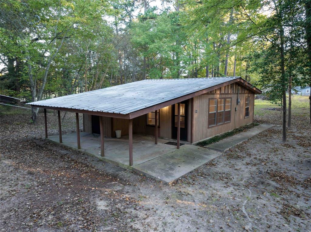 Cozy updated 2 bedroom, 1 bath cabin in the woods located in the gated community of Callender Lake.  This home is located in a very quiet secluded area of this lake community but is a short drive to the 365 acre spring fed Callender Lake.   Home is located on three lots totaling about 0.63 acres.  A large ranch is behind the home which allows you to enjoy nature from your property.  No other homes are very close to this home allowing you serenity and peaceful environment.  Home has new carpet in living and bedroom areas and new luxury vinyl flooring throughout the rest of the home.  Home does not have appliances or central heat and air.  Three AC window units will come with the home .  Callender Lake community has a boat ramp, fishing pier, children's park, lake swim area, great fishing, and so much more for your enjoyment.  Only site built homes are allowed in this community.  Come and see this one of a kind property today and start living the East TX lake life.