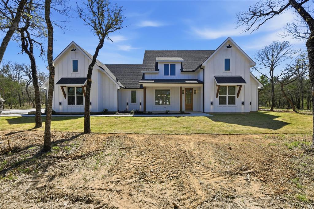 WOW—stunning new custom home on 2.68 heavily treed acres in the sought-after Silver Lakes Ranch on Amon G. Carter Lake! Tucked among mature trees, this property offers the perfect blend of privacy, space, and upgrades throughout.

As you arrive, you’ll love the peaceful setting and inviting curb appeal. The property also features a detached garage-shop with electricity and insulated roll-up door—perfect for storage, hobbies, or outdoor equipment.

Inside, you’re welcomed by vaulted ceilings, a statement light fixture, and an open, airy layout. The living room is filled with natural light and features a cozy fireplace, built-ins, and beautiful views of the wooded acreage.

The kitchen is a standout with quartz countertops, oversized island, breakfast bar, built-in microwave, Butler’s pantry, and a large walk-in pantry. The bright eat-in area is perfect for everyday living or entertaining.

The primary suite offers a spa-like bath with soaking tub, separate shower, dual sinks, and a large walk-in closet. On the opposite side, you’ll find three additional bedrooms plus a flexible space ideal for an office, game room, or second living area. With 3.5 baths, there’s room for everyone.

Energy-efficient features include spray foam insulation, tankless water heater, and Pella doors and windows for added comfort and efficiency year-round.

Enjoy the covered back patio overlooking peaceful, scenic surroundings—ideal for morning coffee, evening sunsets, or entertaining guests. There’s plenty of room to add a pool, garden, or create your own outdoor retreat.

Silver Lakes Ranch offers community amenities including a pool, clubhouse, fishing dock, boat dock access, and more—all set among rolling hills and wide-open views that make this area so special.

Don’t miss this incredible opportunity to own a brand-new home with space, privacy, and a true country-living feel!