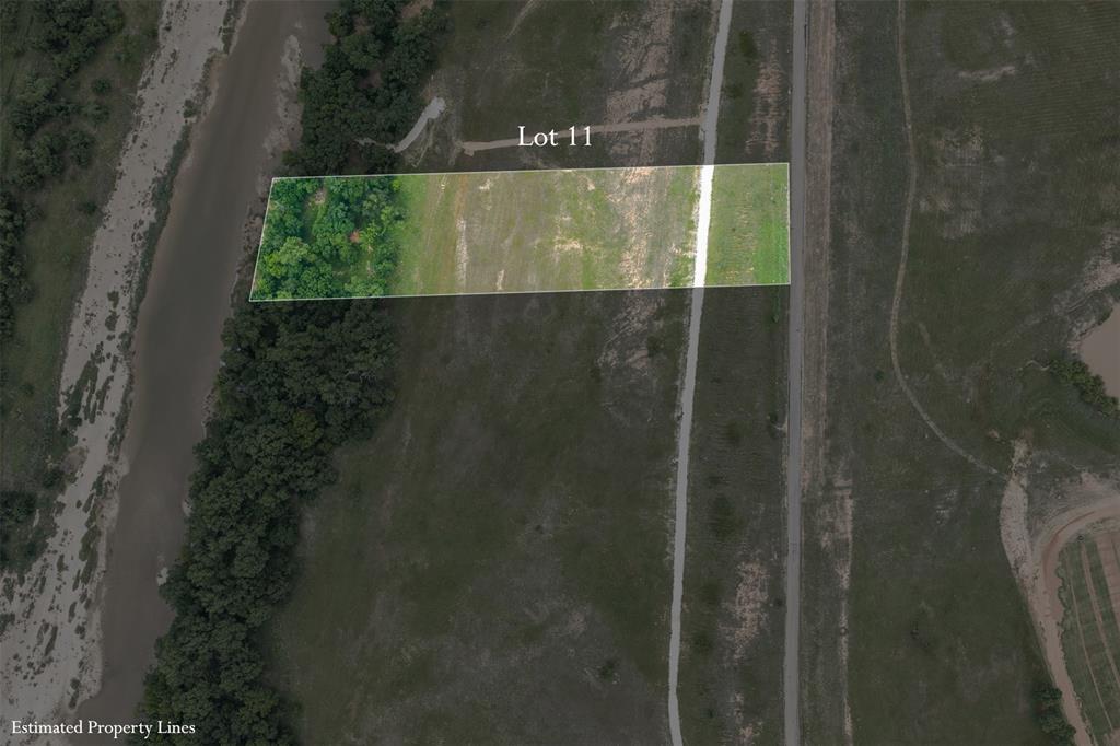 One of the most unique parcels in the area, Lot 11 offers direct frontage along a scenic river, giving you that rare combination of open pastureland and lush, wooded riverbank all in one property. From the paved road, the lot opens up into a wide, grassy clearing before transitioning into a beautiful canopy of mature hardwoods that line the river's edge — a natural paradise for fishermen, or anyone who simply loves the outdoors.
Aerial views reveal the incredible setting: sweeping green pastures, multiple ponds nearby, and miles of unspoiled Texas countryside stretching in every direction. The property benefits from paved road frontage and an internal drive, making access easy while still feeling completely removed from city life.
Whether you're envisioning a private riverside retreat, a hunting camp, or a custom home site with a view money can't buy, Lot 11 delivers. Abundant wildlife, and the peaceful sounds of the river — this is Texas land ownership at its finest, just a short drive from Fort Worth.