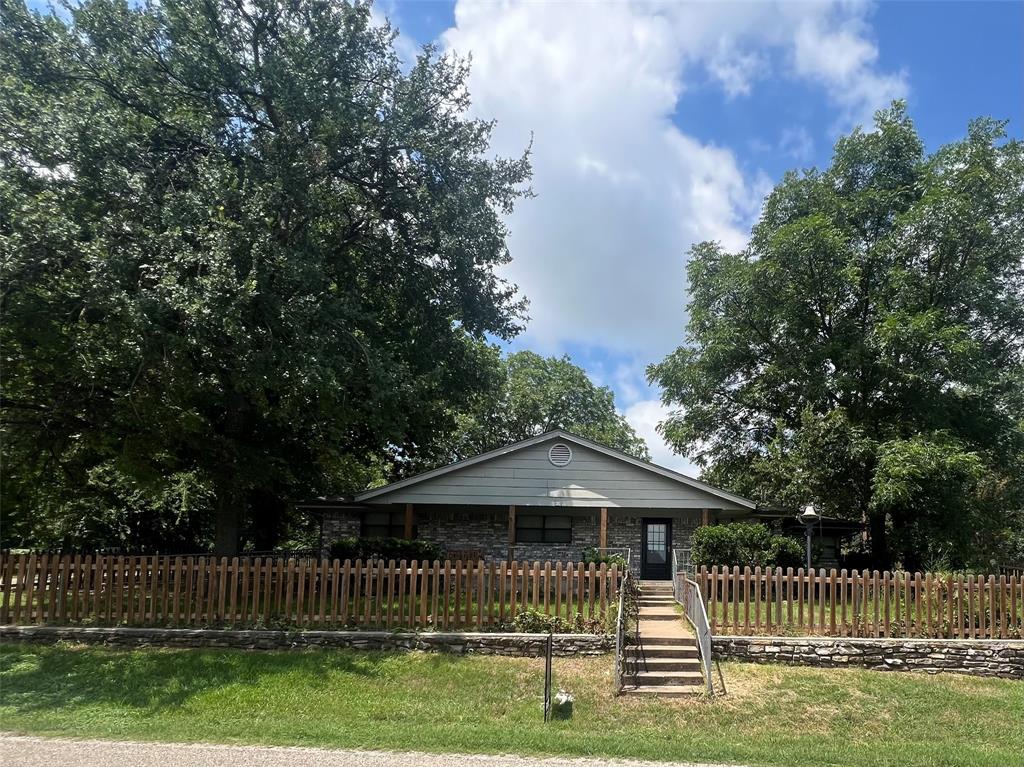 Charming lakeside community home on 3 spacious lots perfect as a cozy full-time residence or your dream vacation retreat! There are also 3 additional lots adjoining that are part of the price. These 3 lots could be sold, or used for expanding parking, gardening, or anything like that. Enjoy lake living with easy access to boating, fishing, and relaxation. The open floor plan feels bright and welcoming, ideal for gatherings or quiet evenings around a great fireplace. Relax on the large covered front porch with morning coffee and breezes. Mature trees offer plenty of shade and privacy, while the oversized covered carport patio provides versatile space for entertaining, vehicles, or sheltering your RV or boat.  Features its own private well and community water is also available. This shaded, property has great potential for selling some of the lots and still have room! New roof installed March 21, 2026. Very Motivated Seller!! Vacant and ready to show on short notice!