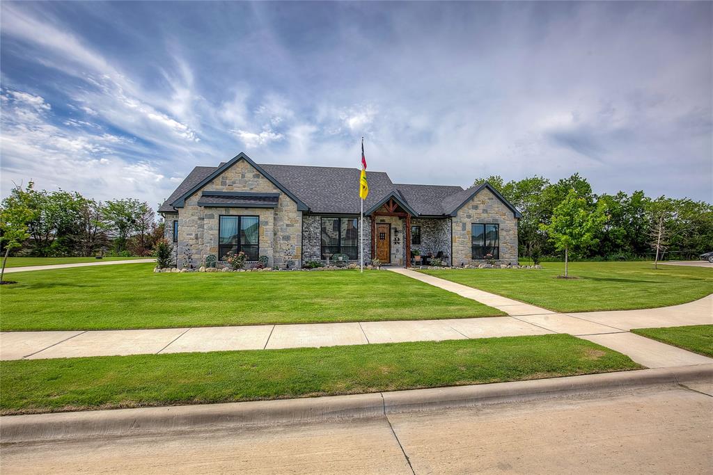 Welcome to this stunning custom home in The Mills, one of Caddo Mills’ most coveted communities. Set on a beautifully landscaped half-acre lot, this home impresses with striking stonework and an open-concept design.The gourmet kitchen features an expansive island and gas cooktop, flowing seamlessly into a light-filled living area overlooking the covered patio. 

The private primary suite offers a spa-level retreat with dual vanities, a walk-in double shower, and an oversized soaking tub. Two additional bedrooms are thoughtfully connected by a Jack-and-Jill bathroom. At the front of the home, a dedicated office or flex room offers inspiring views of the landscaped front yard—perfect for working, reading, or simply unwinding. The home includes a half bath to add convenience for visitors.

Additional luxuries include an extended garage accommodating a full-size truck, a built-in dog-washing station, and a dedicated dog run enclosed by an upgraded 8-foot privacy fence.

The owners are retiring to the country and ready to pass along their well-loved home to its next chapter!
