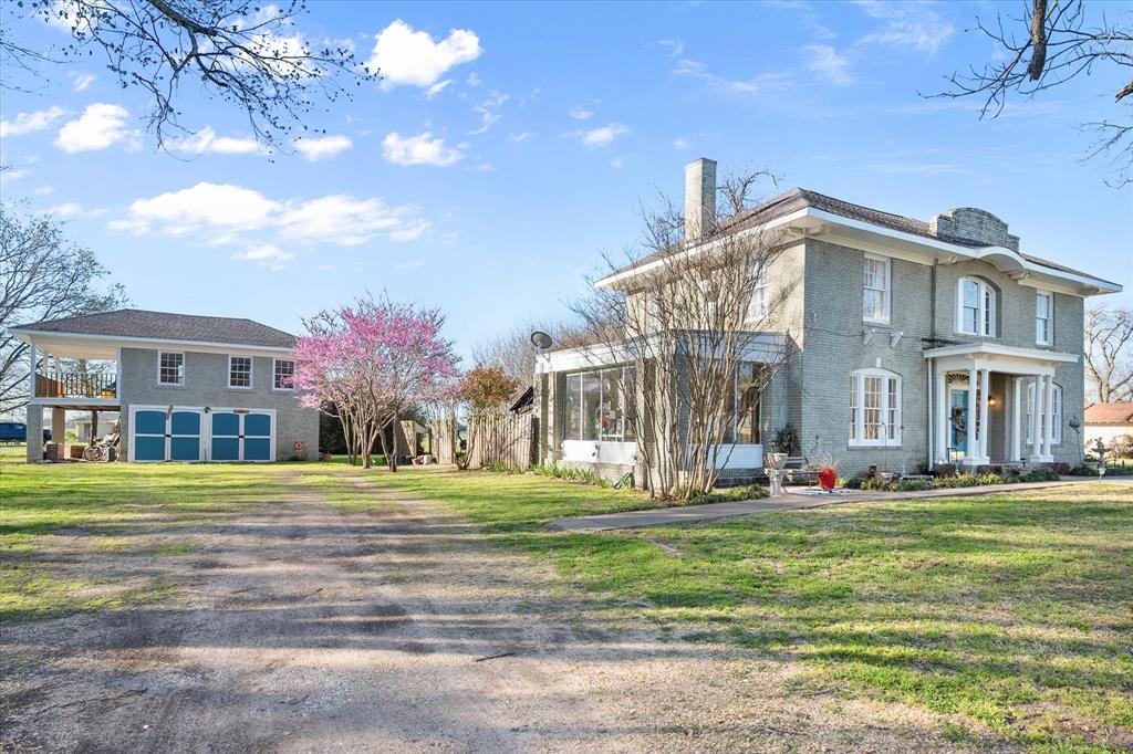 Step into timeless character with this beautifully preserved historic home, where classic details and thoughtful design come together on a spacious corner lot. Original oak floors, elegant French doors, and abundant natural light create a warm and inviting atmosphere throughout. The home features a formal dining room ideal for gatherings, along with an enclosed sunroom that offers a quiet space to relax and unwind. A butler’s pantry with a separate staircase adds both charm and functionality, highlighting the home’s unique architectural features. Outside, a private patio area provides a comfortable setting for outdoor enjoyment or entertaining. The original carriage house adds even more versatility, featuring two upstairs rooms that can be utilized as a home office, guest space, or additional living area. With a blend of historic character and flexible living options, this property offers a rare opportunity to own a truly distinctive home.
