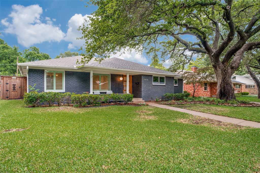 Imagine morning coffee beneath a canopy of mature trees, afternoons spent in a spacious backyard, and evenings gathered on the patio with family and friends. Situated on an oversized .253-acre lot in sought-after Merriman Manor, this beautifully updated one-story home offers the perfect blend of comfort, convenience, and the established charm that makes East Dallas so desirable. Featuring 2,236 square feet, 3 bedrooms, 2.1 baths, a dedicated office, and an attached 2-car garage with epoxy floor, the flexible floor plan easily accommodates today's lifestyles. Extensive improvements completed between 2020 and 2026 provide the benefits of updated systems and finishes while preserving the character buyers love in established neighborhoods. The light-filled living room is anchored by a wood-burning fireplace and opens directly to the backyard patio, creating an ideal setting for everyday living and entertaining. The remodeled kitchen features quartz countertops, stainless steel appliances, updated cabinetry, generous storage, and an open design that connects seamlessly to the living and dining areas. The private primary suite offers a walk-in closet, built-in dressing area cabinetry, and an updated bath with walk-in shower. Two secondary bedrooms share a hall bath with dual sinks. The dedicated office provides exceptional flexibility and can easily function as a home office, gym, playroom, craft room, or second living area. A separate laundry room adds convenience. The expansive backyard is a true highlight, offering mature landscaping, abundant green space, privacy, and ample room for a future pool. Additional exterior features include a board-on-board wood fence and motorized driveway gate. Major updates include remodeled kitchen and bathrooms (2020), roof (2020), HVAC replacement (2020), windows replaced (2020), board-on-board fence (2020), motorized driveway gate (2020), gutters installed (2022), water heater replaced (2026), most wood floors refinished (2026).