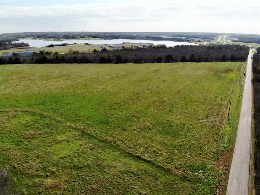 Discover the possibilities with this rare 30-acre opportunity just outside Ennis, Texas in sought after Ellis County. Offered as two parcels sold together, this property features approximately 1,950 feet of road frontage & combines an existing homesite with expansive agricultural acreage, creating exceptional potential for rural living, investment, recreation, or future development. The first parcel, approximately 2 acres, includes an existing as-is home & barn. The residence will require significant renovation or removal, making this an ideal setup for buyers seeking an established homesite with room to build a custom home, restore the existing improvements, or create a private country retreat. The second parcel offers approximately 28 acres with a pond & is currently ag-exempt land used for hay production. This open acreage provides versatility for livestock, farming, recreational use, or simply enjoying the privacy & wide-open space that rural Texas living offers. Conveniently located just minutes from downtown Ennis, the property delivers the peace of the countryside with easy access to local shops, dining, schools, & major highways connecting to Waxahachie, Corsicana, & the Dallas-Fort Worth metroplex. It is also ideally positioned near Ennis Municipal Airport, Texas Motorplex, & Lakes Bardwell and Clark.
With 30 acres across two parcels, substantial road frontage, existing improvements, & productive agricultural land, this property presents a compelling opportunity to create a private homestead, weekend retreat, working ranch setup, or long-term land investment in growing Ellis County.

Buyer to verify utilities, zoning, acreage, exemptions, & development potential. Existing electricity service is set up. New owners will need to establish water service through Rockett SUD. Showings by appointment via SupraOne. Use caution when entering overgrown areas of the property. Parcels #190369 and #190368 to be sold together.
