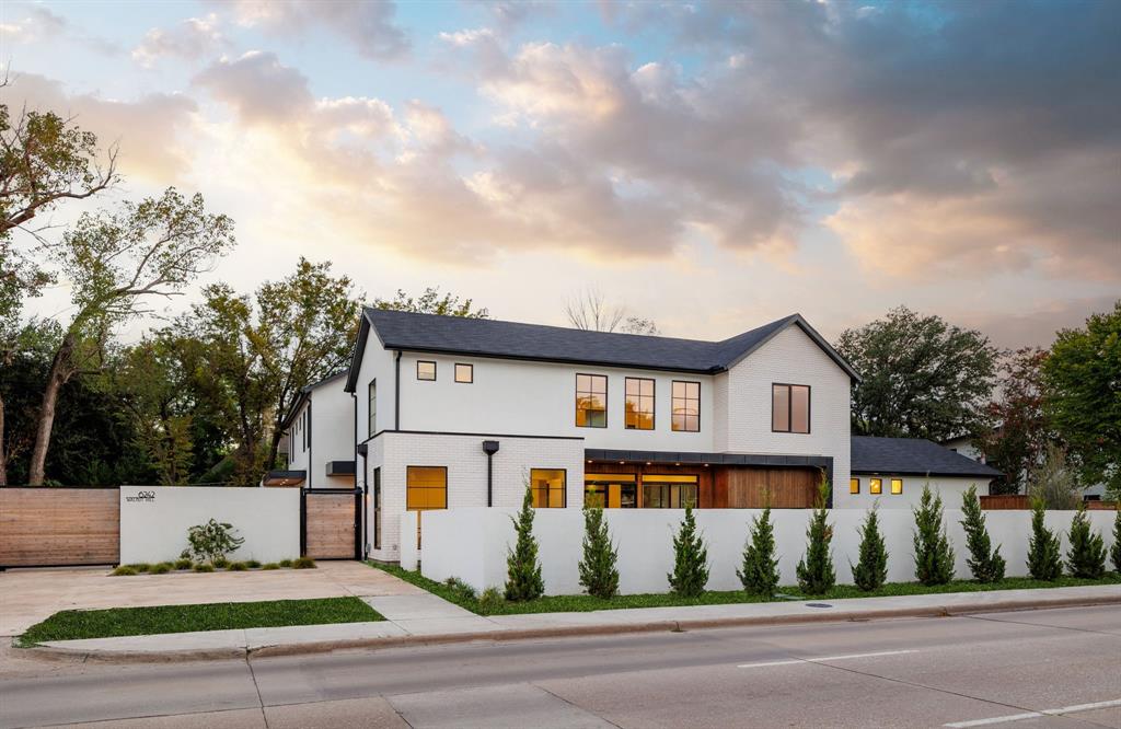 Step into a world of modern elegance and sophistication in this stunning new Texas modern home, where impeccable design meets unparalleled craftsmanship. Ensconced behind a private gated entrance in prestigious Preston Hollow, this architectural showplace offers a perfect blend of luxury, privacy, and contemporary living. The centerpiece of the home is the gourmet kitchen, featuring a dramatic 12-foot center island, custom cabinetry, high-end appliances, and a generous walk-in pantry—ideal for both casual meals and grand entertaining. Open-concept layout seamlessly connects the kitchen to the living and dining areas, perfect for gatherings with family and friends. Spacious primary retreat features private entrance to the backyard, spa-like en-suite bathroom, and expansive walk-in closet. Enjoy beautifully integrated indoor-outdoor living space with large sliding glass doors that open to a covered terrace, ideal for entertaining and enhanced by mature landscaping and greenspace.