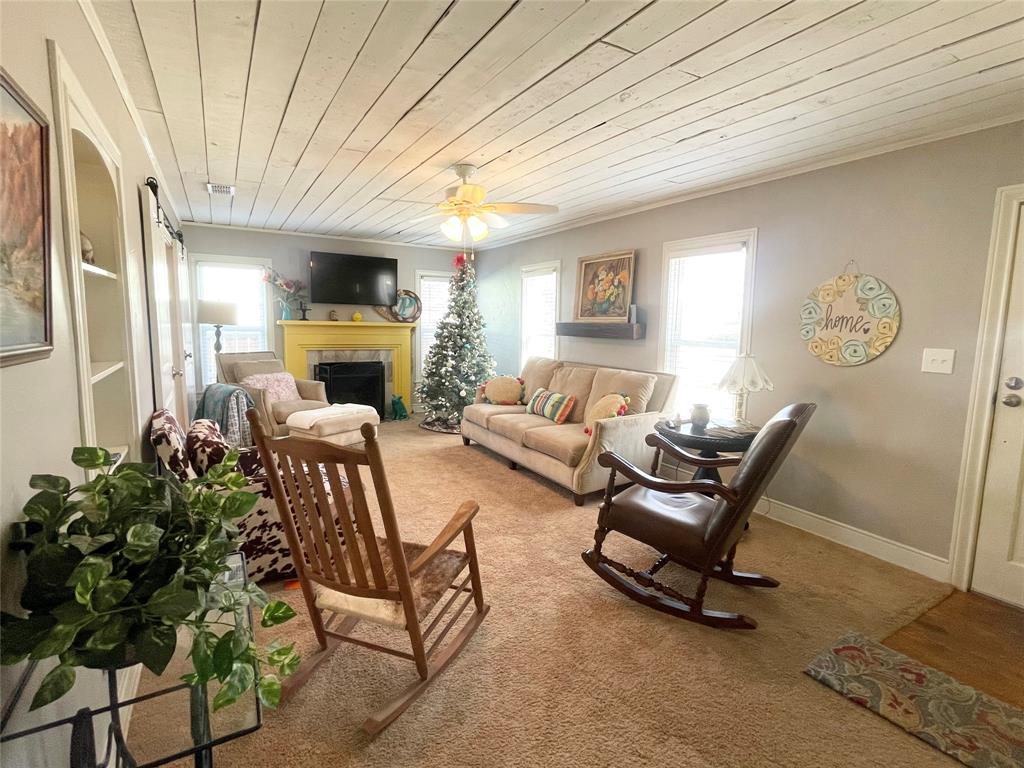 Need a home and all the furnishings? This cutest bungalow in Graham is officially on the market! This home was fully renovated in 2019, new cedar privacy fence and back patio cover installed in 2020. Two spacious bedrooms One full bath with a tub and shower, formal dining room, den complete with built-in bookcase and wood burning fireplace. New double pane windows with faux wood blinds throughout. The kitchen offers stainless appliances, granite counters and marble tiled floors. Original hardwood floors accentuate the dining room, bedrooms. Carpet finishes out the den and hallway. OVERSIZED backyard is your private oasis. Artificial grass that extends the entire patio area for extra space and easy lawn care. A separately fenced side area that can be used as a dog run is a bonus. Single car garage with a small garden shed off the back side. Separate storage building, and a double back gate. Custom vegetable garden featuring vintage embellished chain link gates, arch and galvanized planting boxes. This home is a rare jewel. Furnished home.