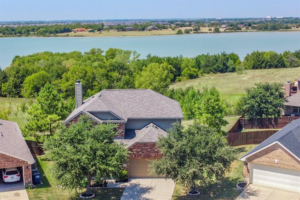 Lakefront home with wonderful views and in a great location! Original owner & one of the first in the neighborhood. He chose this lot as it is one of the largest & had this Beazer home built. He installed a hinge on the back fence to get down to the lake. All bedrooms are located on the second floor for best views. Great open floorplan downstairs with kitchen island overlooking the livingroom. Dining room is open to foyer and would make a great office or game room as well. Wall of windows lakeside keep the house sunny & bright. Lots of big ticket upgrades! Roof replaced in 2020, water heater & AC replaced 2018. Carpet replaced last year. This home is located in Sunset Pointe with walking trails, pools & playground. Home is minutes from Lakeview elementary, LEHS, downtown LE & the DNT. Enjoy great access to Frisco, Dallas & DFW airport. This is the best deal on the lake & will not last long...better make your appointment today to start living the lake life tomorrow!