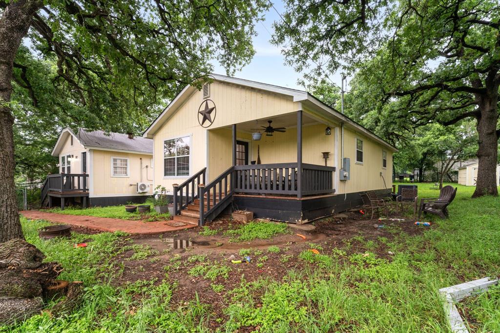 Unique income-producing opportunity at 902 Travis Ave in Alvarado. Corner lot just under .3 acre with mature oak trees and easy access to major highways including Interstate 35W. Property features two separate living spaces with private entrances—ideal for multi-generational use, rental income, or house hacking. Layout offers 3 bedrooms, 2 full baths, 2 kitchens, plus a bonus room for office or flex space. Covered breezeway connects both units. Large backyard with 4 storage units. Minutes from Pirate Cove Water Park for added area appeal. Strong potential with flexibility and space to maximize returns.