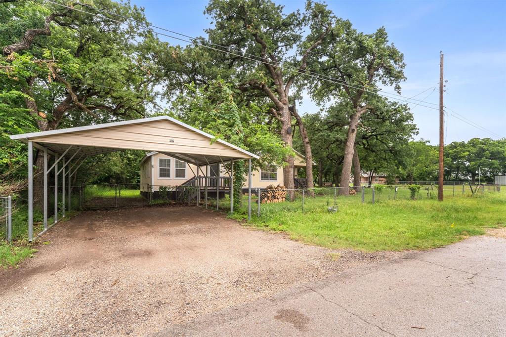 Unique income-producing opportunity at 902 Travis Ave in Alvarado. Corner lot just under .3 acre with mature oak trees and easy access to major highways including Interstate 35W. Property features two separate living spaces with private entrances—ideal for multi-generational use, rental income, or house hacking. Layout offers 3 bedrooms, 2 full baths, 2 kitchens, plus a bonus room for office or flex space. Covered breezeway connects both units. Large backyard with 4 storage units. Minutes from Pirate Cove Water Park for added area appeal. Strong potential with flexibility and space to maximize returns.