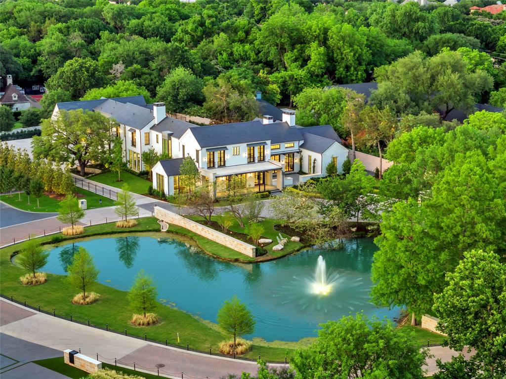 Within the prestigious gates of Crespi Estates, this exceptional estate was completed in 2025-designed by SHM Architects, interiors by Brant McFarlain, landscape design by Lance Dickinson & built by Crescent Estate Custom Homes. Situated on nearly 2 private acres, property offers extraordinary privacy, security & resort-style living. Privately gated entrance creates impressive drive-up appeal with views of lake & water feature. Spanning 11,997 sq ft, home feat 5 ensuite bedrms, 7.2 baths, designed for both grand entertaining & comfortable daily living. Distinguished finishes includ limestone & hardwood flooring, exotic marbles, Waterworks fixtures & designer lighting throughout. Floor-to-ceiling windows flood interiors w natural light & frame views of grounds. Vaulted great rm w oversized FP opens seamlessly to multiple outdoor living areas. Sophisticated lounge w wet bar connects to climate-controlled rm, while formal dining rm is complemented by butler’s pantry. Chef’s kitchen is equipped w Sub-Zero refrigeration, dual Bosch dishwashers, Wolf 60” gas range w infrared griddle, Scotsman ice machine, & adjacent catering kitchen w Miele coffee system & addtl full-size appliances. Keeping rm w FP, private study, mudrm & utility rm complete main level. Primary suite offers serene pool views, morning bar, marble-clad spa bath w freestanding tub & Arabescato Fantastico marble shower, & dual custom walk-in closets. Upstairs 4 ensuite bedrms, a media rm, game rm w wet bar & addtl utility space. Detached guest casita provides added privacy. Resort-style grounds includ covered loggia w FP, infinity-edge pool & spa, putting green, pickleball court, expansive lawn, fire pit & large motor court. Combination of pier-&-beam & slab foundation, stucco & stone exterior, slate & metal roof, 5 Carrier HVAC systems, 3 Navien tankless water heaters & integrated Crestron & Lutron systems, this gated estate represents luxury living in one of Dallas’ most exclusive communities.