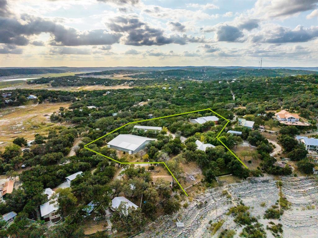 Lakefront property located approximately 30-40 minutes from San Antonio in Pipe Creek, TX. Property includes main residence, guest house, three large insulated showrooms totaling 26,000 Square Feet, and an additional lakefront lot.

Main home (built 2005) features 3 bedrooms, 3.5 baths, and a game room that can function as a 4th bedroom. Interior includes large windows with lake views, kitchen with Viking appliances, and primary suite with private balcony. Property includes a three-slip boat dock.

Guest house is approximately 650 SF with kitchen, two bathrooms, and private living space.

Additional  0.9-acre lakefront lot includes water well, has been cleared, and offers additional lake access.  Total acreage for this property is 9.5 acres

Improvements include three insulated steel-frame showroom buildings:
• 12,000 SF workshop with concrete floors, large roll-up doors, and multiple electrical outlets
• Two 7,000 SF showroom buildings with reinforced construction
• One building includes office and bathroom

Buildings are suitable for storage, workshop use, or potential conversion to other uses.

Six water wells service the property. Seller has acquired most adjoining lots (approx. 6 acres total) creating additional buffer.

Property includes paved road access and over 100 feet of Medina Lake frontage.