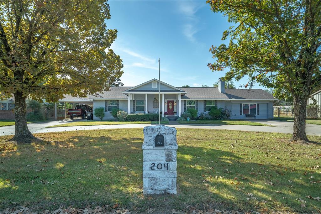 Welcome to this beautifully crafted 4-bedroom, 3-bath brick home located in the highly sought-after Edgewood ISD. With classic Colonial-style charm and modern amenities, this home offers both character and comfort. Situated on nearly an acre (.90), and featuring a circular driveway and a welcoming front porch, the curb appeal is undeniable.

Inside, wood plank hardwood floors create a warm, open feel across the spacious living, dining, and kitchen areas. The living room centers around a cozy fireplace, while the kitchen—with its rustic touches like a wood plank ceiling, eating bar, and dedicated coffee bar—serves as the heart of the home. Stainless steel built-ins (range, microwave, and dishwasher) and a walk-in pantry provide style and functionality.

The large primary suite is a true retreat, featuring a luxurious ensuite bath with a soaking tub, walk-in tile shower, and generous space for a sitting area. Custom built-ins and an adjoining sunroom—perfect as a home office or fitness area—add to its appeal. One of the secondary bedrooms is a former master with its own ensuite, and the other two bedrooms offer unique layouts and character.

Outside, you'll find a huge backyard with an extended patio ideal for grilling or entertaining. The versatile workshop features two separate areas, ready for your creative or practical use.

Additional features include a one-space carport, a stylish barn door to the utility room, and access to the highly regarded Edgewood ISD. Conveniently located near schools, shopping, and dining, this home blends timeless design with everyday livability.