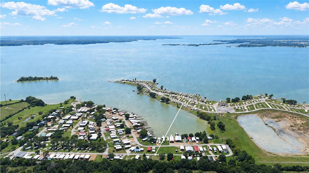 Lake life is calling from Pelican Isle on Richland-Chambers Lake! This improved interior lot in a fun lakeside RV resort community is ready for your weekend getaways, summer lake days, and laid-back outdoor living. Located at 935 Blue Heron Way, Lot 17 offers a cleared 2,091 square foot space with installed utilities, including connected electricity, co-op water, private sewer, underground utilities, and access from a private asphalt road.

Whether you are looking for a recreational retreat, investment opportunity, or an easy lock-and-leave lake escape, this lot gives you a great head start. Storage buildings are already in place, giving you room for lake gear, fishing supplies, tools, outdoor furniture, and weekend essentials. The lot is partially fenced with a backyard-style setup, making it easy to enjoy your own defined space inside the community.

Pelican Isle is packed with amenities designed for lake-area fun, including a boat ramp, community dock, clubhouse, community pool, laundry facilities, fishing areas, park, playground, gated access, and RV parking. Spend your days boating on Richland-Chambers Lake, relaxing by the pool, visiting with neighbors, or enjoying the easygoing atmosphere that makes this community so special.

Want even more room? The adjacent Lot 16 is also available, giving buyers a unique opportunity to purchase side-by-side lots in Pelican Isle. See Lot 16 MLS #21307420 for additional details. Buy one or explore the possibility of owning both and create your own expanded lake-area retreat!