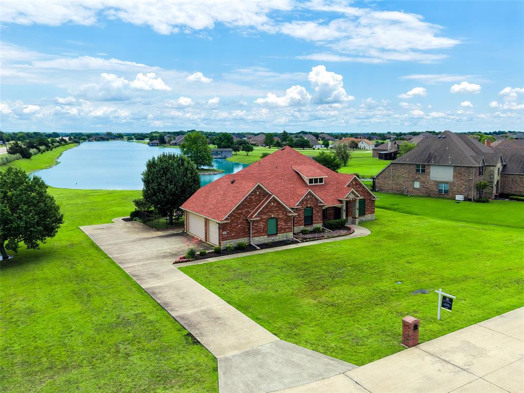Experience luxury lakefront living with the convenience of the city in this stunning custom home located in the highly sought-after Princeton Lakes community. Situated on a rare 1-acre waterfront lot, this elegant 4-bedroom, 3-bath residence offers breathtaking panoramic lake views right from your own backyard—creating a peaceful retreat just minutes from shopping, dining, and entertainment. Qualified buyers may receive up to $5,600 in lender credit towards closing costs!

The home features two spacious living areas, rich wood flooring, crown molding, and beautiful custom architectural details throughout. The thoughtfully designed split-bedroom layout provides privacy, while the versatile second living area can easily serve as a home office, study, formal living room, or library.

At the heart of the home is an inviting open-concept kitchen with a large granite island, granite countertops, and a striking tumbled stone backsplash—perfect for entertaining or everyday living. The luxurious primary suite offers a relaxing sitting area and a spa-like bathroom complete with a garden jetted tub, creating the perfect place to unwind while enjoying tranquil lake views.

Additional features include a 3-car garage with built-in cabinets, workbench, and storage, two water heaters, a central vacuum system, and a spacious utility room with a wet sink, cabinetry, and dedicated freezer space. The attic offers excellent potential for a future upstairs conversion, providing even more flexibility.

Step outside to enjoy the serene waterfront setting, complete with a wrought iron pet area and full sprinkler system. Residents of Princeton Lakes enjoy exclusive access to four private lakes and are just minutes from Lake Lavon, offering endless opportunities for recreation while still enjoying the convenience of city living.

This exceptional property combines peaceful lakefront serenity with modern luxury and everyday convenience—a rare opportunity you won’t want to miss.