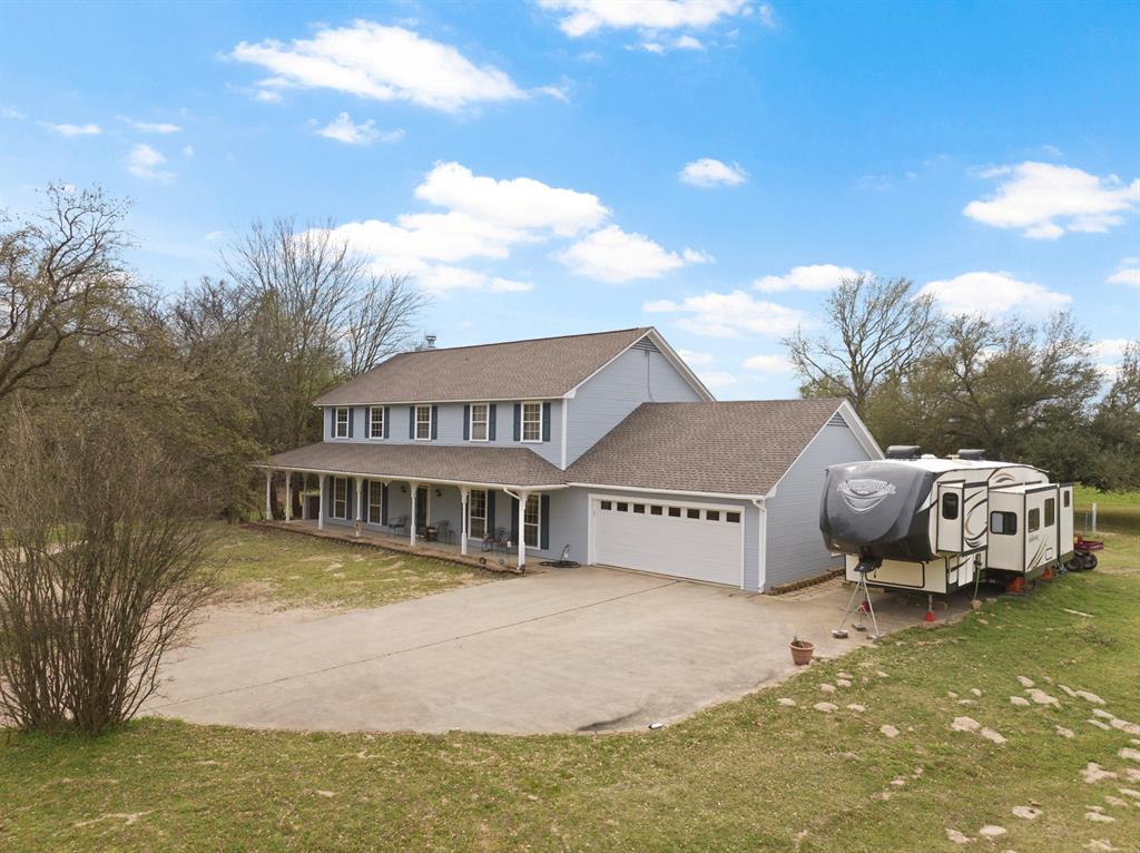 The perfect blend of space, function, and charm! Spacious and beautifully maintained, this 2,800 sq ft two story home sits on over an acre and offers room to live, work, and relax. Enjoy the charm of a wrap around porch and the comfort of multiple living spaces, including a cozy living room with a wood burning fireplace, a second living area or den, and a separate office.The spacious kitchen provides plenty of room for gathering and entertaining. The home also features a whole house central vac system. Recent upgrades add peace of mind, including a new aerobic system, roof, exterior paint, decking, garage door, a new front storm door, and an HVAC system only 6 years old. With a shop on the property and plenty of outdoor space to enjoy, this property combines quiet country life with functional amenities.