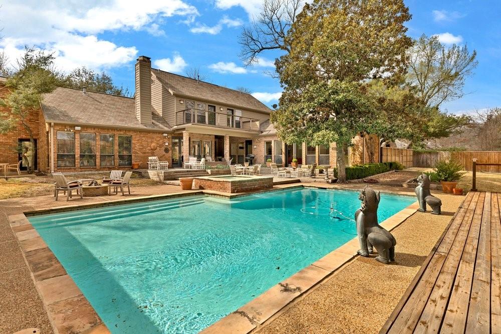 Exceptional opportunity in Janmar Circle, one of Dallas’ most sought-after neighborhoods, with no HOA. Situated on a 0.63-acre lot along a wide tree-lined street, this 4,388 SF home offers privacy, space, and timeless appeal. Abundant natural light fills the well-designed floor plan featuring 4 beds and 6 baths, formal living and dining areas, three fireplaces, and a spacious den with a wet bar. The first-level primary suite provides comfort and convenience, while the second-level includes a versatile flex space, two additional bedrooms with en-suite baths, and a balcony overlooking the backyard. Designed for both grand-scale entertaining and intimate gatherings, the backyard is a true showpiece. Enjoy a resort-style pool with an attached spa, expansive decking, multiple seating areas, and an elegant covered pavilion. Professionally landscaped front and rear grounds enhance the home’s private outdoor setting. Notable upgrades include a gas fire pit, 3 outdoor ceiling fans, 22 perimeter lights with timers, security system including motion detectors and glass breaks, fresh interior paint, foundation repair, new water heaters, new driveway, sump pumps in the front and rear yards, and epoxy flooring in the three-car garage. Meticulously maintained and ideally located near top-rated private schools, premier shopping and dining, this home is ready with the option to enjoy as-is, renovate, or build custom.