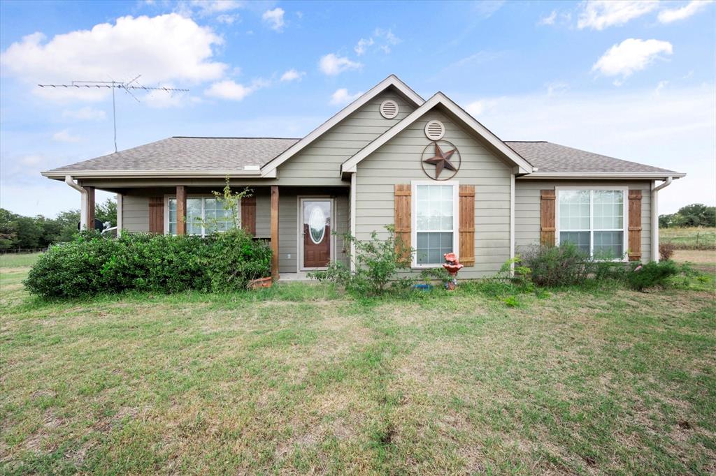 Experience the serenity of rural living in this adorable single-owner United built home, nestled on a generously sized 0.67-acre lot. The property boasts a well-designed floor plan that seamlessly combines the kitchen, living area, and dining space, creating an inviting open concept living experience. The kitchen is a standout feature, complete with a charming island breakfast bar accented by elegant hanging pendant lights. Most of the home is adorned with wood-look tile flooring, while the bedrooms provide carpeting. The Master bedroom offers a private en suite bathroom, featuring a dual sink vanity, a spacious walk-in shower, and an ample walk-in closet. Off the kitchen you will find a full-size laundry room equipped with a storage closet. Step outside, and you'll discover a fully fenced yard along with a convenient carport. This property is the essence of peaceful country living, making it a truly exceptional place to call home.