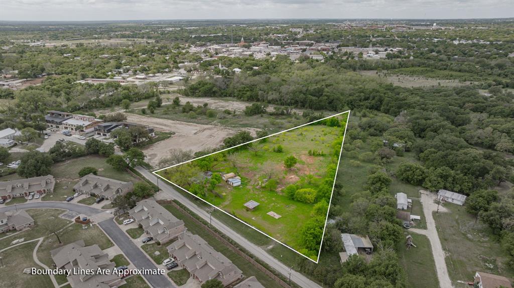 Builders, Developers, Investors... LOOK HERE! This is an exceptional 3.51-acre tract, located just off W Washington, in one of Stephenville's fastest-growing corridors. Surrounded by brand new and established Multi-Family construction, this is the ideal location, on pavement, for your next Multi-Family project. This location offers both convenience and opportunity to downtown Stephenville, the Bosque River Trail, and the wildly trending Tarleton State University. Situated on the east side of town, this location also provides easy access to the very busy Highway 281, and Highway 377. The city has just recently stubbed out a multi-family sewer line at the rear neighboring boundary of the property. Currently, a 1012 SQ FT, 2-bedroom, 1-bath rental home sits on the property.