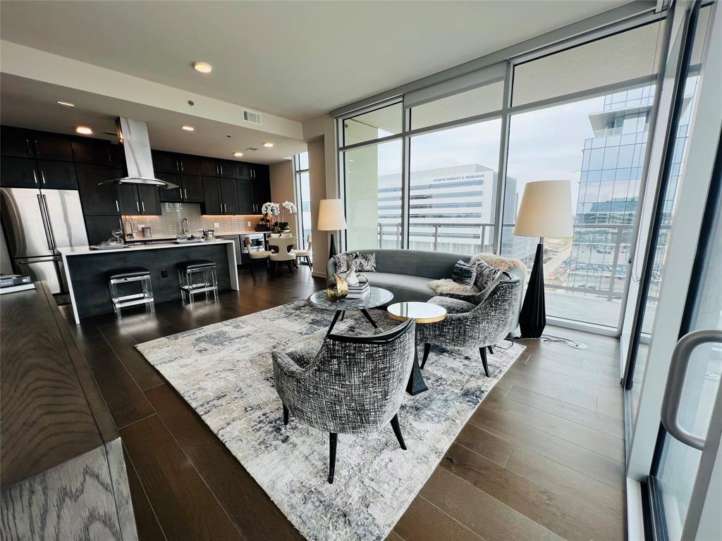 Welcome to luxury living at its finest! This stunning unit offers a plethora of impressive features and amenities! Step into your fully equipped kitchen that boasts an induction stove top, smart oven, and a dual zone wine fridge,all packaged together with top-of-the-line GE appliances. Enjoy the convenience of an in-unit washer and dryer, and the privacy of roller shades on all windows. Parking is made easy with a reserved spot for your car and for those busy weekends, you'll appreciate the complimentary valet service.The building itself is a resort-like oasis that features a heated pool, hot tub and state-of-the-art fitness center. 24-hour concierge service is here to help you with anything you need.As an added bonus, we'll cover the initiation fees for both Cowboys Club and Cowboys Fit membership, so you can stay active and engaged with the local community. Don't miss out on the opportunity to live in luxury with all of these amazing features and amenities!