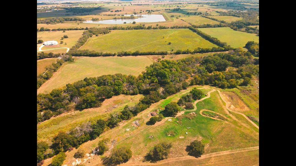 Discover 71 remarkable acres in a highly desirable corridor just minutes from Sanger and convenient to Interstate 35, offering a rare blend of accessibility, privacy, and possibility. This expansive property features gently rolling terrain, open pasture, scattered trees, and a creek corridor creating a natural greenbelt buffer that enhances privacy, wildlife habitat, and scenic character. The low-water crossing and creek area contribute to the property’s charm and natural separation, offering a sense of retreat while serving as a buffer from surrounding growth.

Ideally positioned near town conveniences yet insulated from urban sprawl, this property offers the feel of a private ranch setting with exceptional access for commuting, recreation, livestock, or a future estate. With abundant space to roam and a setting that balances seclusion with connectivity, this is a rare opportunity to own a significant acreage tract in a sought-after North Texas location.