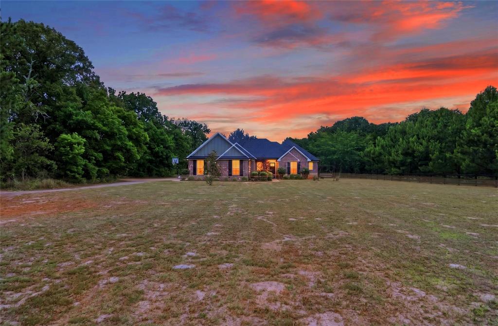 Are you looking for SERENITY NOW! SERENITY NOW!? 
Then THIS is the property for you! Over 2.6 acres of peace and quiet, nestled in the woods of East Texas.  Built in 2019, this beautiful 4-bedroom, 2-bath home offers 2,148 sq. ft. of comfortable living space on 2.6 wooded acres and is minutes from both I-20 and Loop 49, providing ease for commuting. Designed with both comfort and functionality in mind, the home features a gas log fireplace, spacious living and dining areas, and plenty of room to entertain and play. The private primary suite includes a large walk-in closet, separate shower, and freestanding tub for a relaxing retreat. Three other bedroom provide ample room for others. The 4th bedroom can be used as an office if desired. Walk outside to hear nothing but the sound of nature! The back area is perfect for entertaining and features a covered patio and an uncovered area suitable for grilling or soaking up the sun. The rear part of the property has an easement that goes to the edge of the former Garden Valley Golf course.  Come see this hidden jewel!!!