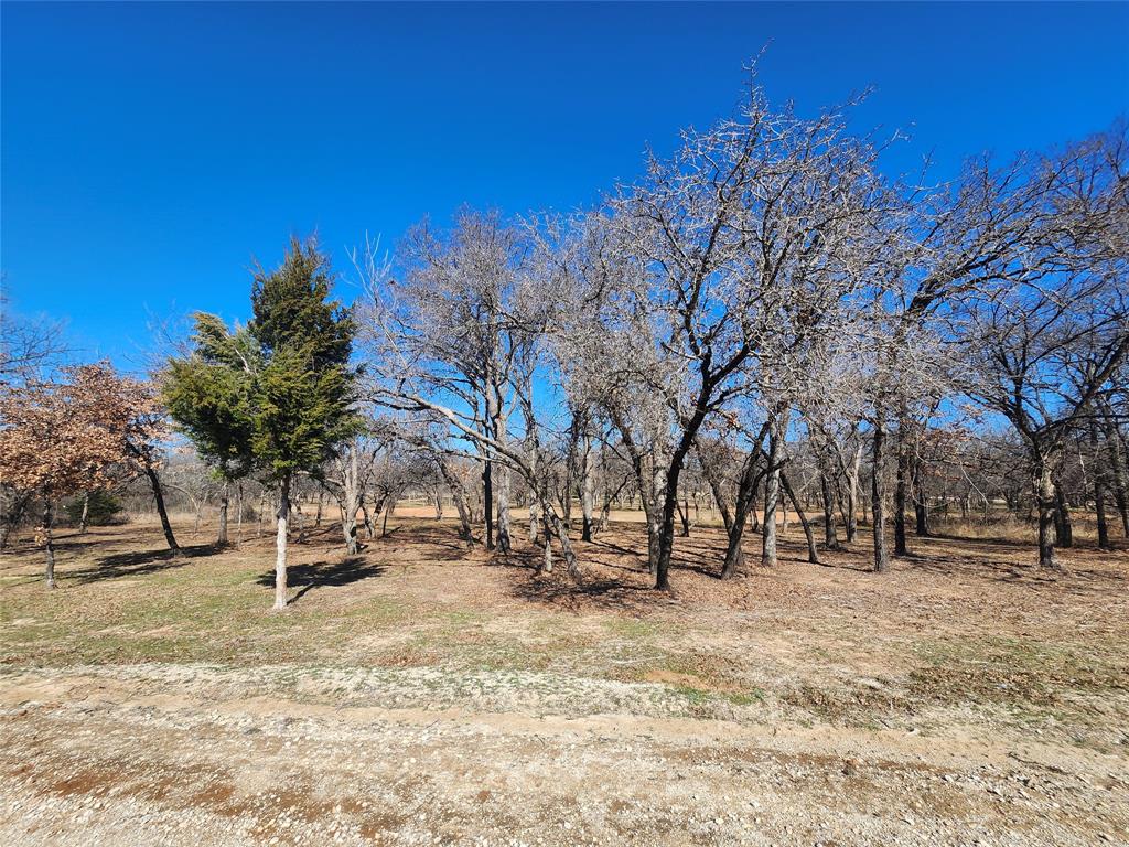 Nice half acre building site lot with mature oak trees to build your future home. This lot backs up to Barefoot creek. Lots are surrounded by the tranquility of nature as you will often see deer all around the property. Nocona Hills offers a 24-hour guarded gated community with access to two private lakes (one listed as top 5 Bass fishing in Texas)a community boat ramp and dock, as well as an 18-hole golf course with driving range, an airstrip, campgrounds with RV sites, and more. Utilities include co-op water and electric already at street. Fiber optic high speed internet is also available. Nearby surroundings include historic downtown Nocona, a winery, brewery and just a short drive to Saint Jo, Muenster and popular Casinos. Come see this gem. 
Owner has multiple lots available to choose from, please contact listing agent for details.  The Club house is under remodel along with the pool such an exciting new Update for the community.
