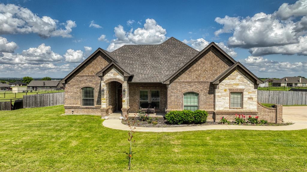 Welcome to your slice of country charm in Paradise! Situated on a spacious 1-acre lot with a fully fenced backyard, this beautifully maintained home offers the perfect blend of comfort, style, and peaceful living. With just under 2,200 square feet, this 4-bedroom, 2-bath home features an open-concept layout designed for both everyday living and entertaining. The generous living room flows seamlessly into a stunning eat-in kitchen, complete with custom painted cabinetry, stainless steel appliances, leathered granite countertops, a large island with seating, and space for a dining table. A floor-to-ceiling stone fireplace anchors the living area, while oversized windows fill the home with natural light and showcase scenic backyard views. The private primary suite offers a relaxing retreat with a spacious layout, dual vanities, a soaking tub, separate tile shower, and a large walk-in closet that conveniently connects to the spacious laundry room with abundant cabinet and counter space. On the opposite side of the home, you’ll find well-sized guest bedrooms and a shared bath. 4th bedroom could be used as an office. This property really has it all and with peace of mind with engineered post-tension cable slab, energy efficient insulation, & HVAC! Enjoy the freedom of country living with NO city taxes and NO HOA, all while being just minutes from town, and within easy reach of Springtown, Decatur, and the DFW Metroplex. Txt keyword TEXAS2 to 88000 for Virtual Tour & more!