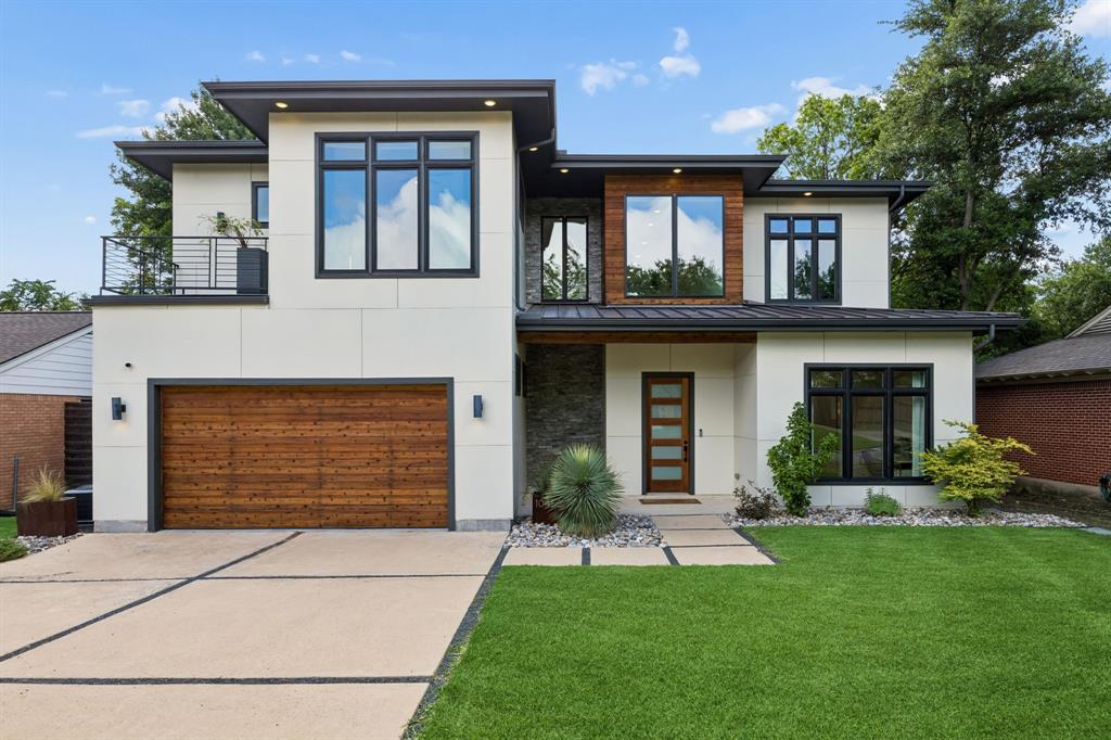Tucked into the sought-after Old Lake Highlands area, this exceptional modern residence offers the perfect balance of luxury, comfort, and connection to nature. Designed for professionals and those who appreciate refined living, the home combines sophisticated finishes with thoughtfully designed spaces for everyday living and entertaining. Soaring 10-foot ceilings on both levels and expansive open-concept living areas create a sense of light and openness throughout. The first-floor primary suite provides a private retreat, while the dedicated office offers an ideal work-from-home environment. At the center of the home is a beautifully appointed kitchen featuring rich stained wood cabinetry, a dramatic waterfall island, abundant workspace, built-in microwave drawer, Bertazzoni commercial-style gas range and dishwasher, and premium built-in Liebherr refrigeration. Seamless indoor-outdoor living defines the experience of this home. Three oversized sliding glass doors, including remarkable 16-foot and 20-foot openings, invite the outdoors in and create a natural extension of the living space. The backyard serves as a private sanctuary with extensive patio areas, low-maintenance artificial turf, and a custom-built firepit with seating, all surrounded by tranquil views. Two balconies provide additional outdoor living spaces, including an upstairs balcony overlooking the backyard. Built with a steel frame and spray foam insulation, the home delivers exceptional durability and energy efficiency. Modern conveniences include a Rachio sprinkler system, Ring doorbell, Nest thermostat, smart garage door opener, and smart front door lock. Every detail has been carefully considered, creating a residence equally suited for productive workdays, elegant entertaining, and peaceful moments immersed in nature. Just minutes from White Rock Lake, dining, shopping, and downtown Dallas, this home offers a rare opportunity to enjoy a luxury lifestyle without sacrificing convenience.