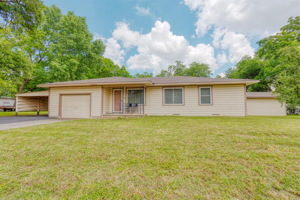 Step back into the warmth of a true 1963 classic, lovingly maintained and full of character. Rich wood paneling, built-in cabinetry, and original charm carry through this 3-bedroom, 1.5-bath home in the heart of Pilot Point. At 1,245 square feet, it lives comfortably with a spacious living room, a generous dining area open to the kitchen, and a bright wall of windows overlooking the backyard. The kitchen keeps its timeless wood cabinets, ample counter space, and a pantry, with stainless range and dishwasher. Each bedroom is roomy and light-filled, and the home stays cozy year-round with central heat and air.
Outside is where this property really shines: a deep 0.24-acre lot shaded by mature pecan trees, fully usable and ready for gardens, gatherings, or simply room to breathe. A large detached storage building offers space for tools, hobbies, or a project shop, and you'll appreciate the attached garage plus covered carport. No HOA. Pilot Point ISD and just minutes from the historic downtown square, shopping, and Hwy 377.
Homes with this kind of solid construction, original character, and oversized lot don't come along often. Move in and enjoy as-is, or add your own personal touches over time. Come see it before it's gone.